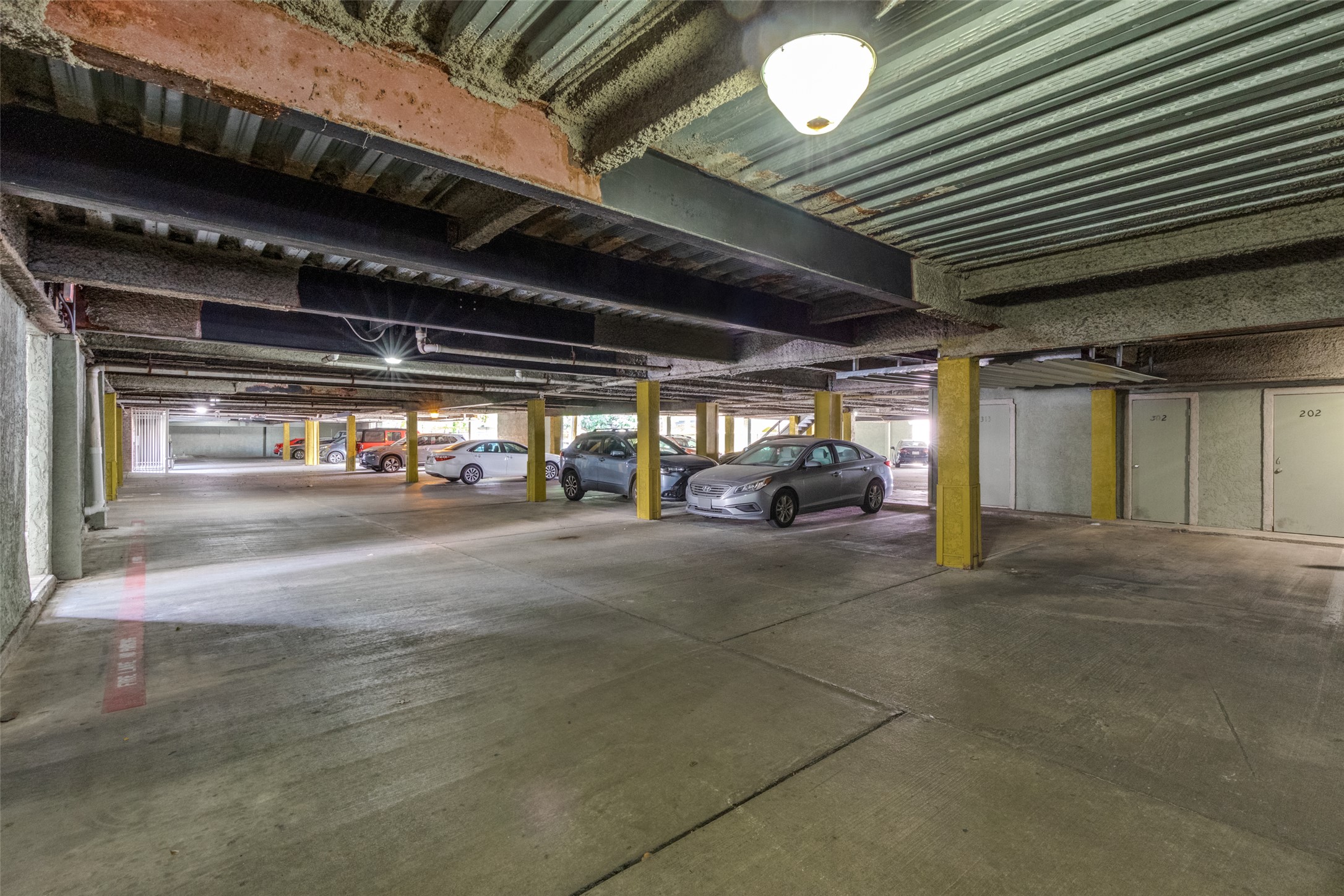 807 West 25th Street, Unit 214 Austin, TX 78705 - Photo 11 of 26 a view of parking garage with cars