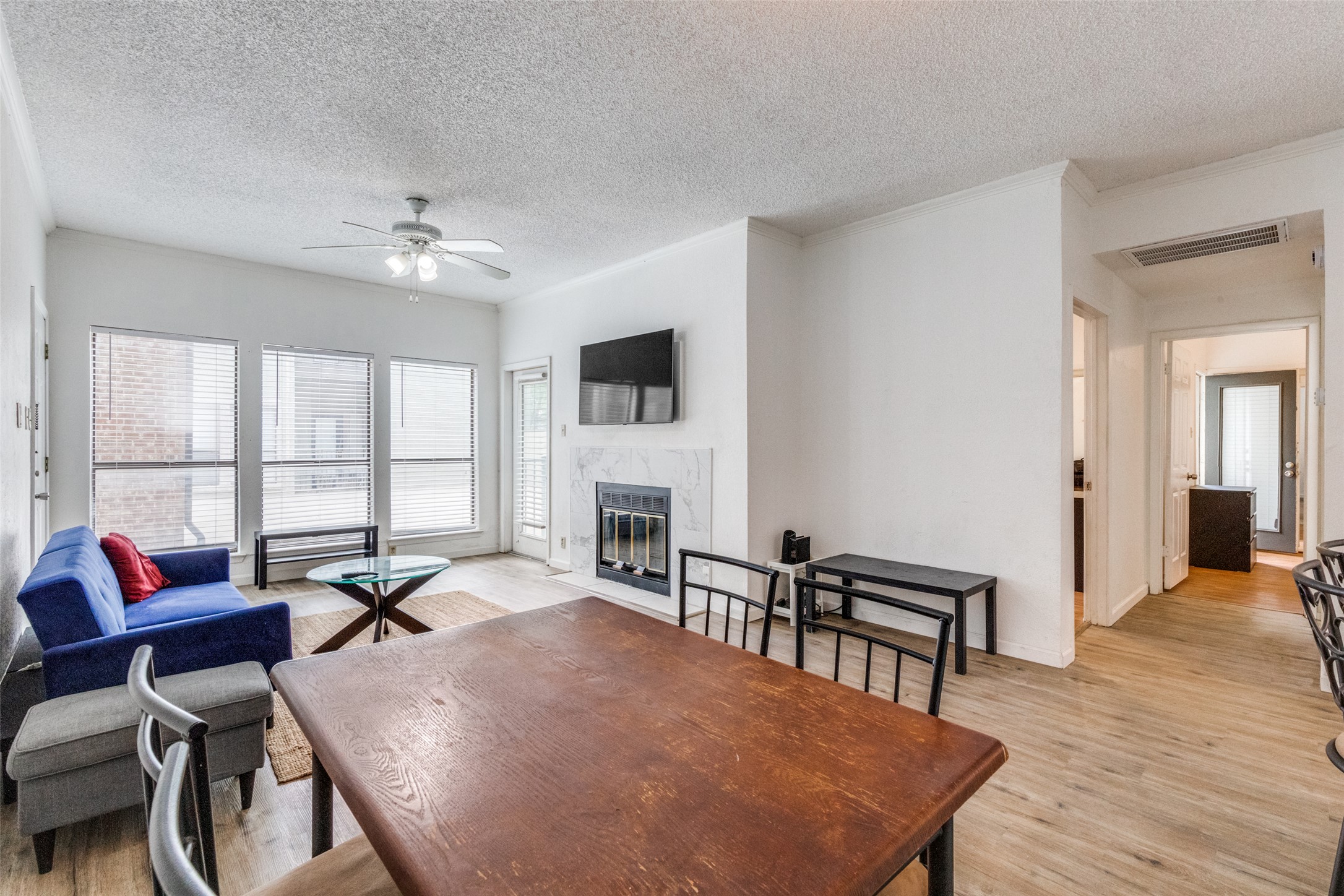 807 West 25th Street, Unit 214 Austin, TX 78705 - Photo 14 of 26 a living room with furniture a fireplace and a table
