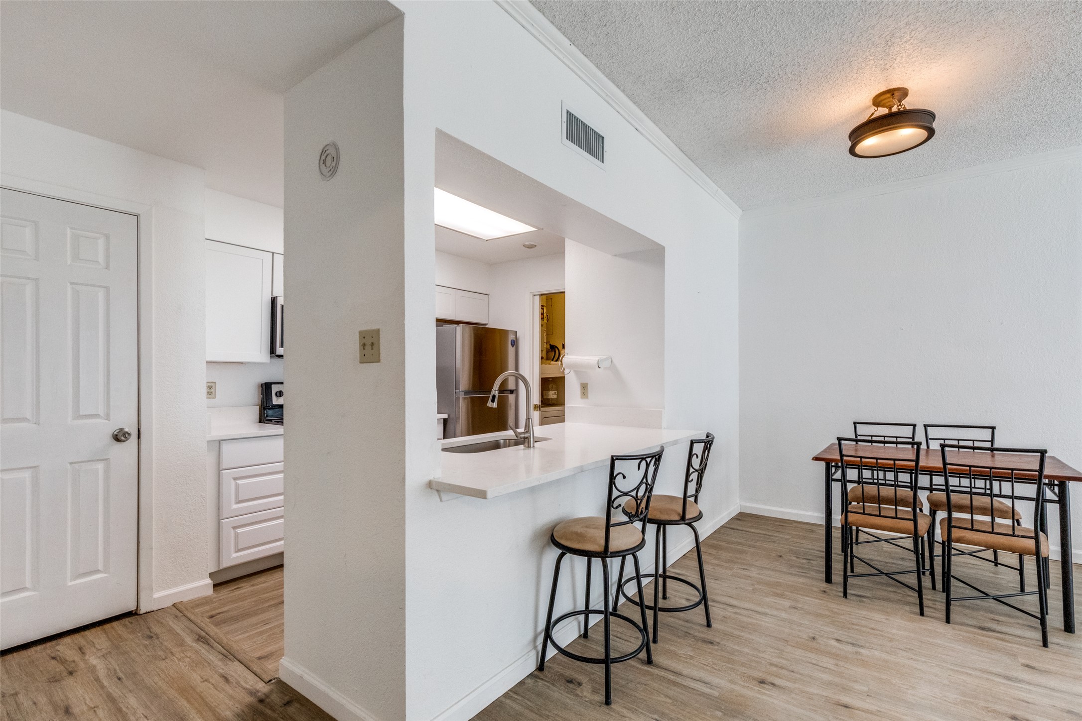 807 West 25th Street, Unit 214 Austin, TX 78705 - Photo 15 of 26 a view of a dining room with furniture and wooden floor