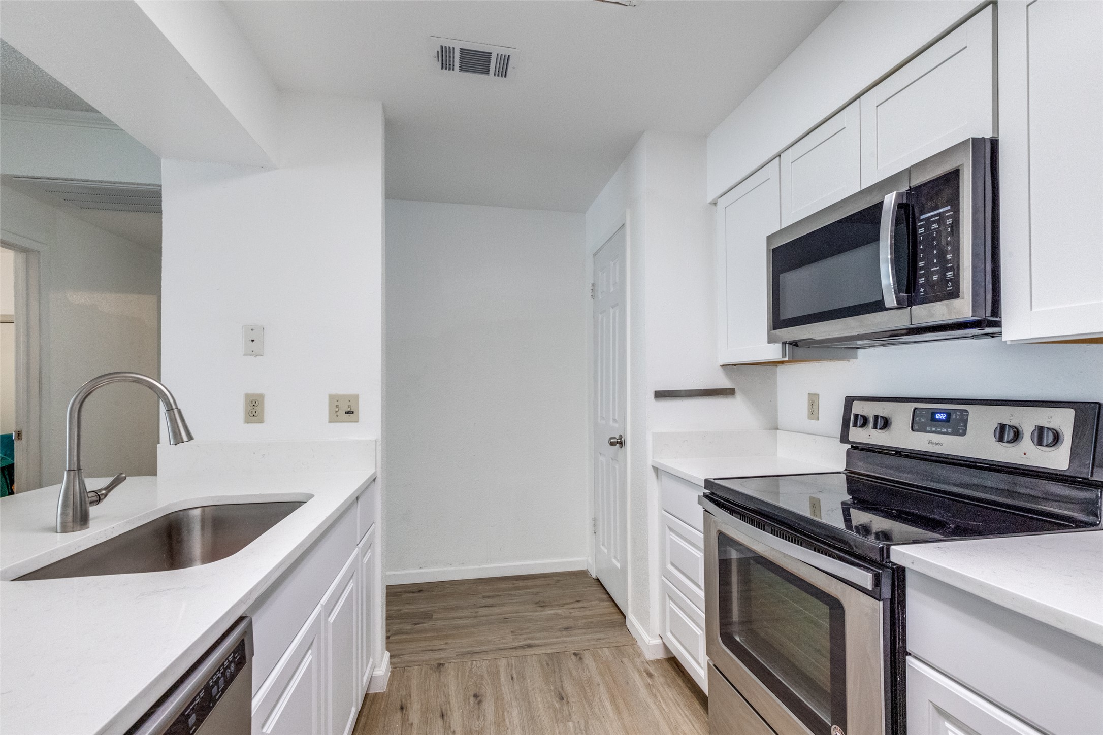 807 West 25th Street, Unit 214 Austin, TX 78705 - Photo 19 of 26 a kitchen with stainless steel appliances a stove microwave and sink
