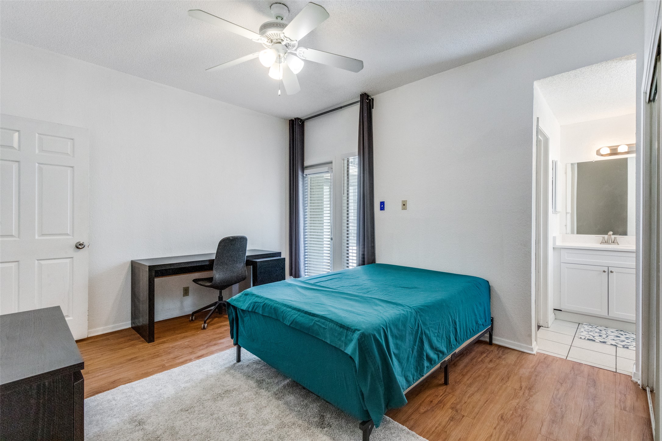 807 West 25th Street, Unit 214 Austin, TX 78705 - Photo 20 of 26 a bedroom with a bed and a chandelier