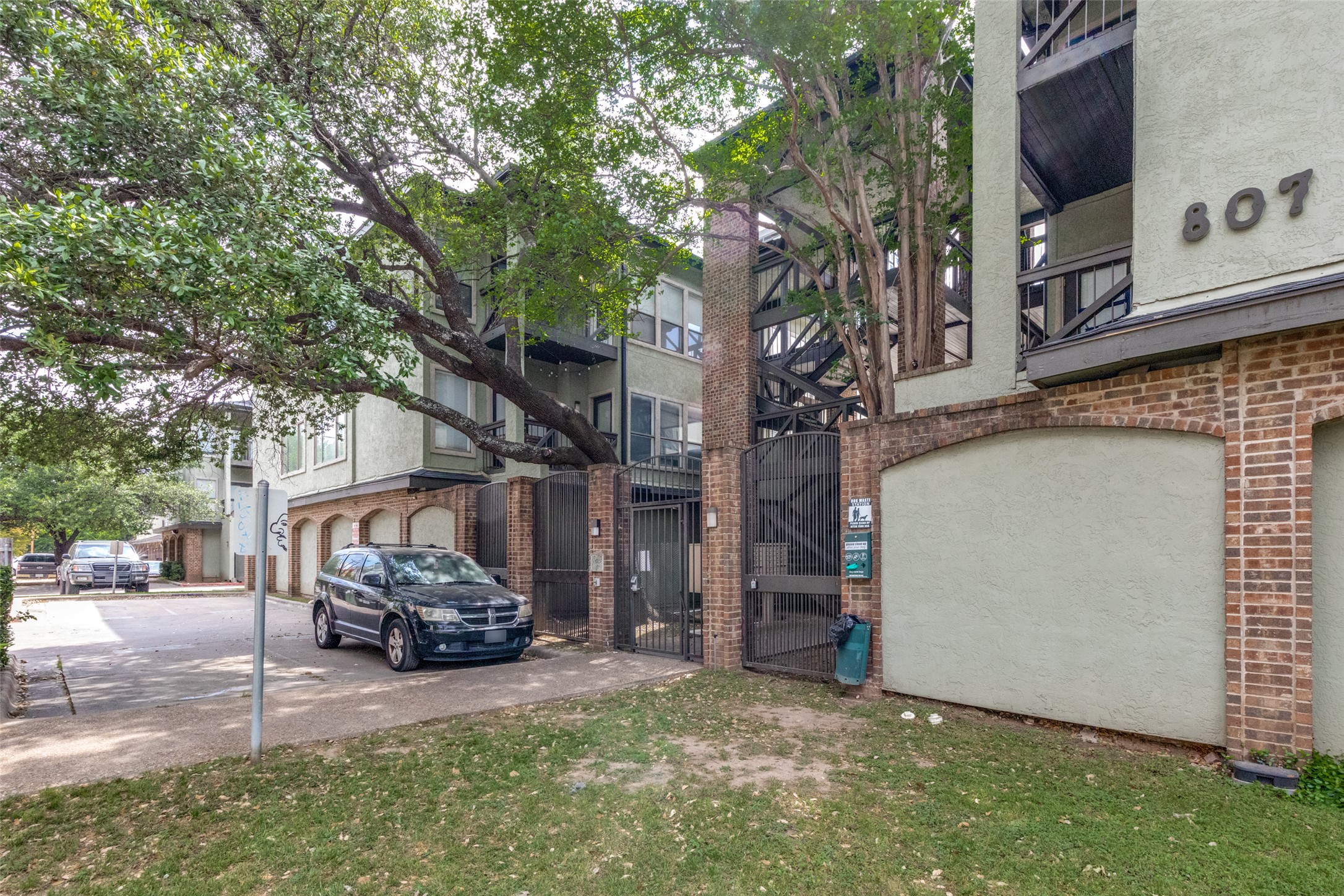 807 West 25th Street, Unit 214 Austin, TX 78705 - Photo 2 of 26 a view of a car park in front of house