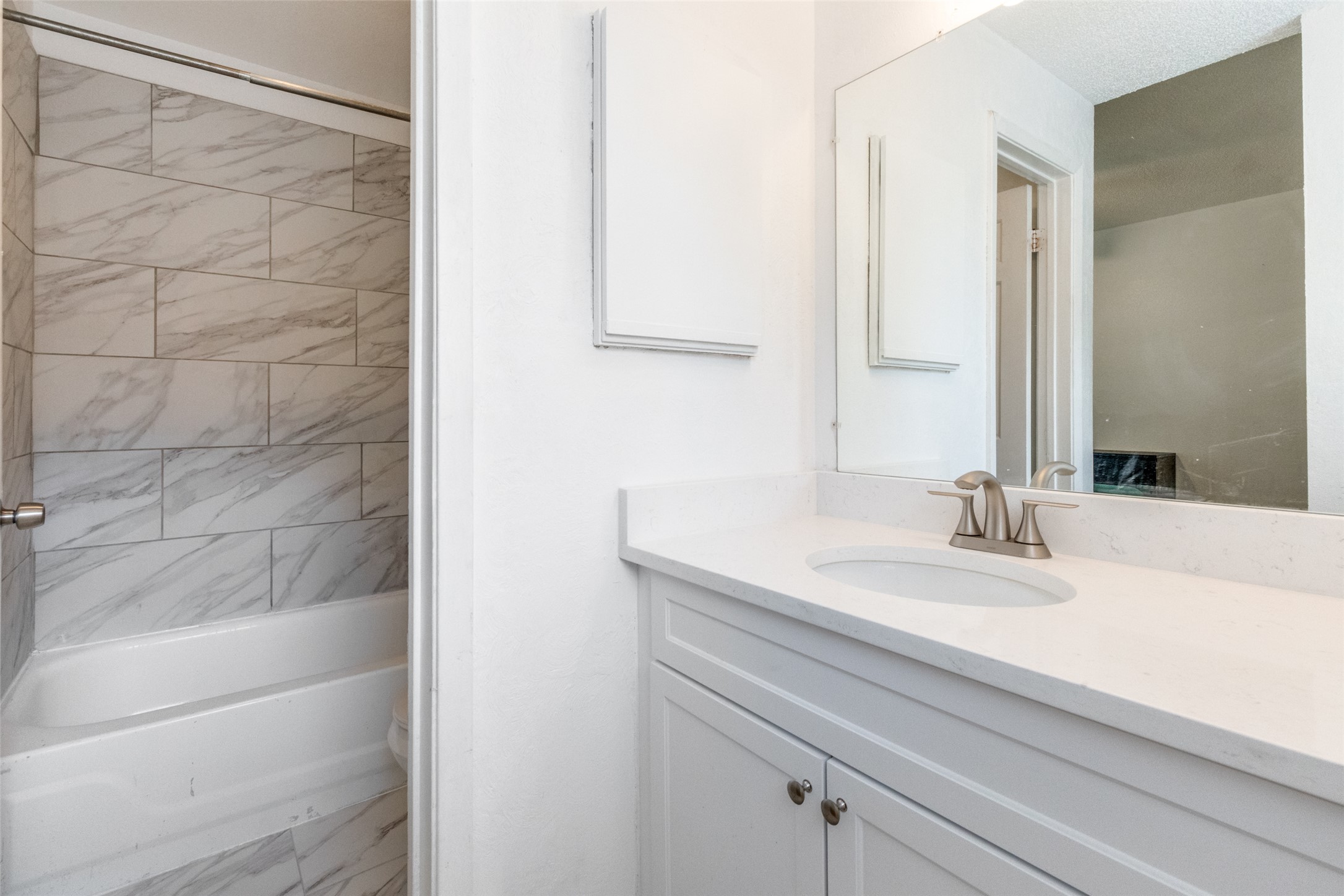 807 West 25th Street, Unit 214 Austin, TX 78705 - Photo 21 of 26 a bathroom with a granite countertop sink and a mirror