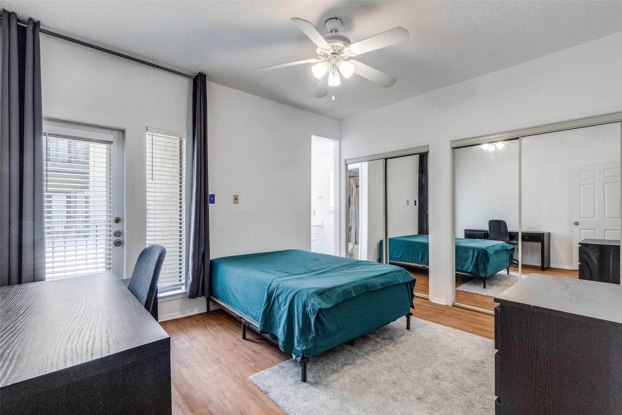 807 West 25th Street, Unit 214 Austin, TX 78705 - Photo 22 of 26 a living room with a bed furniture and a large window