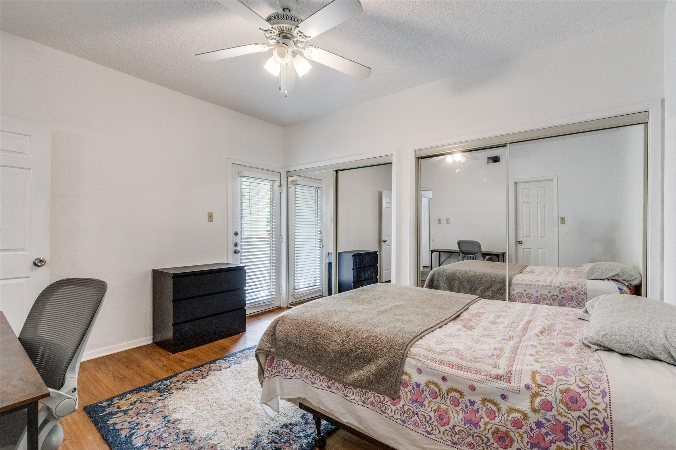 807 West 25th Street, Unit 214 Austin, TX 78705 - Photo 24 of 26 a bedroom with a bed and furniture