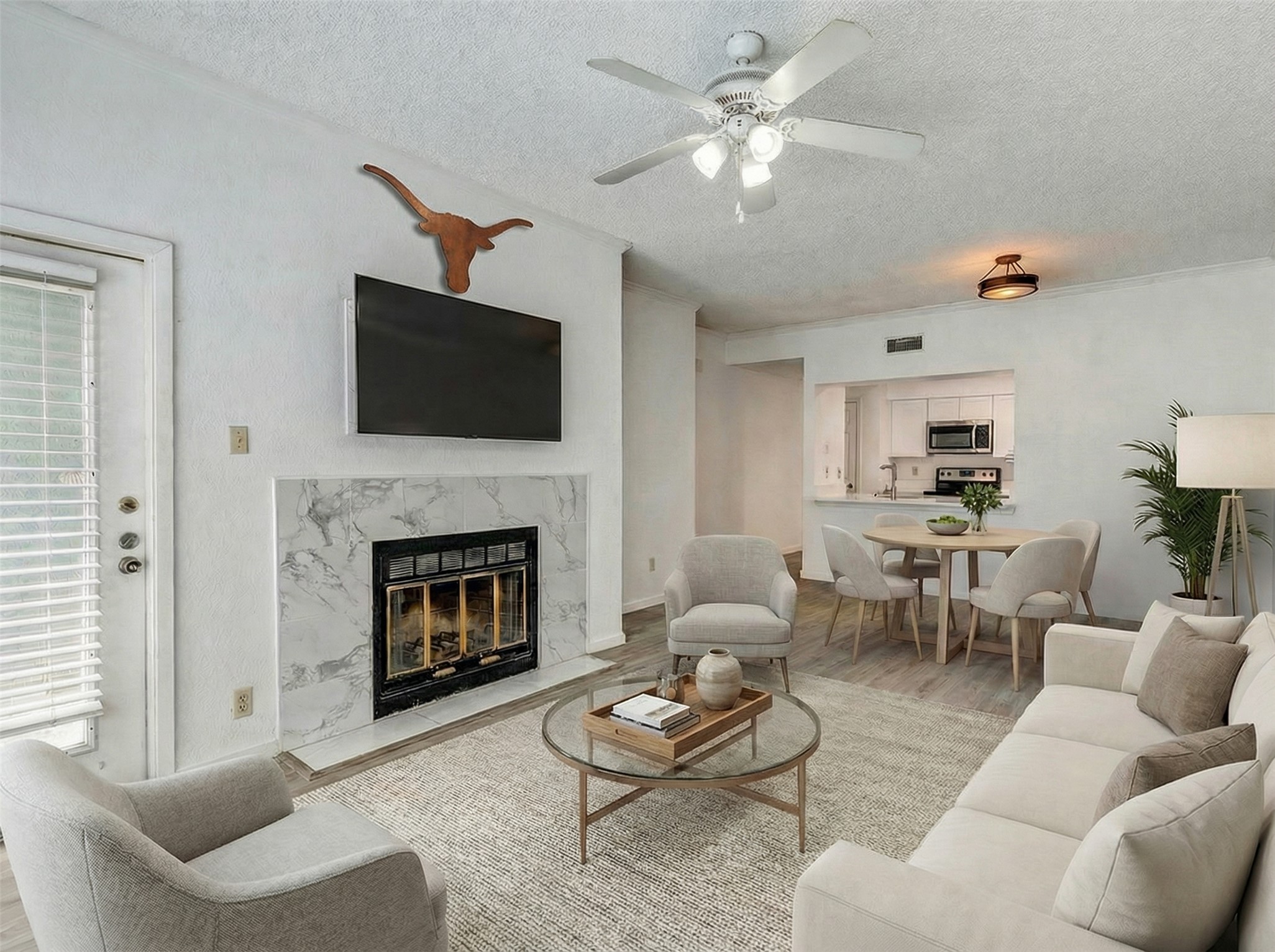 807 West 25th Street, Unit 214 Austin, TX 78705 - Photo 3 of 26 a living room with furniture a fireplace and a flat screen tv