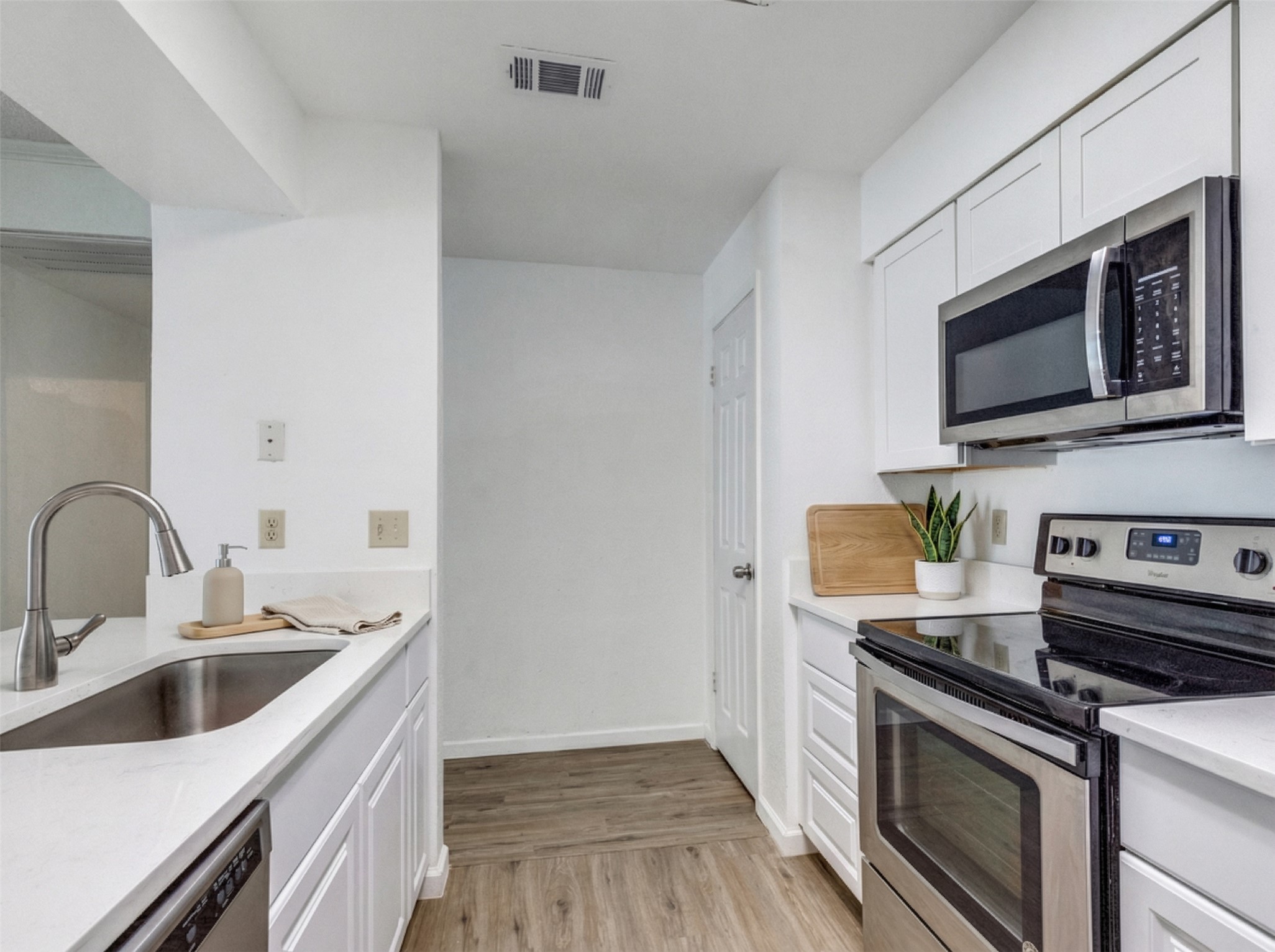 807 West 25th Street, Unit 214 Austin, TX 78705 - Photo 4 of 26 a kitchen with stainless steel appliances a stove microwave and sink