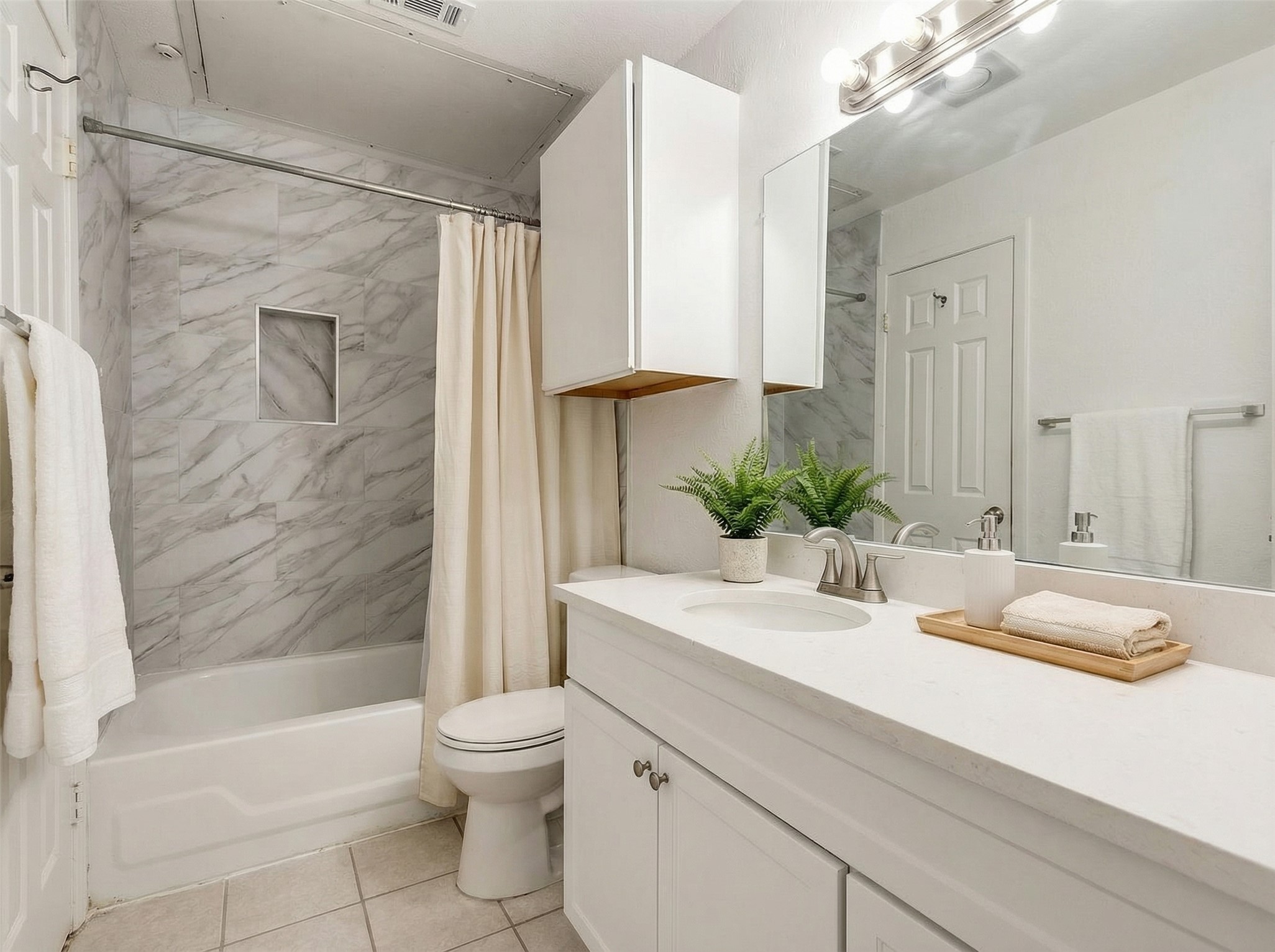 807 West 25th Street, Unit 214 Austin, TX 78705 - Photo 7 of 26 a bathroom with a granite countertop sink a toilet and bathtub