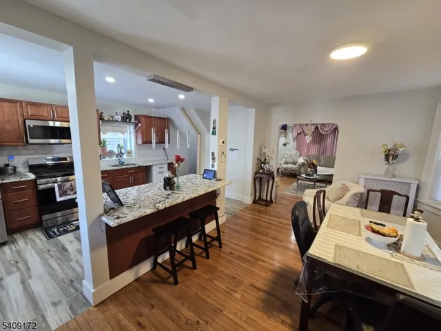 a living room with stainless steel appliances kitchen island granite countertop furniture and a kitchen view