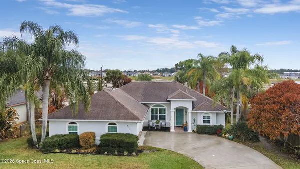 a aerial view of a house next to a yard