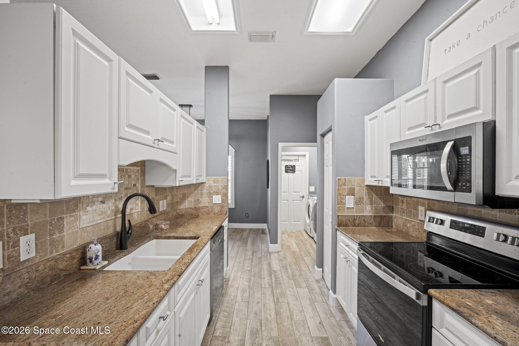 472 Arbor Street Sebastian, FL 32958 - Photo 11 of 33 a kitchen with stainless steel appliances granite countertop a sink stove and refrigerator