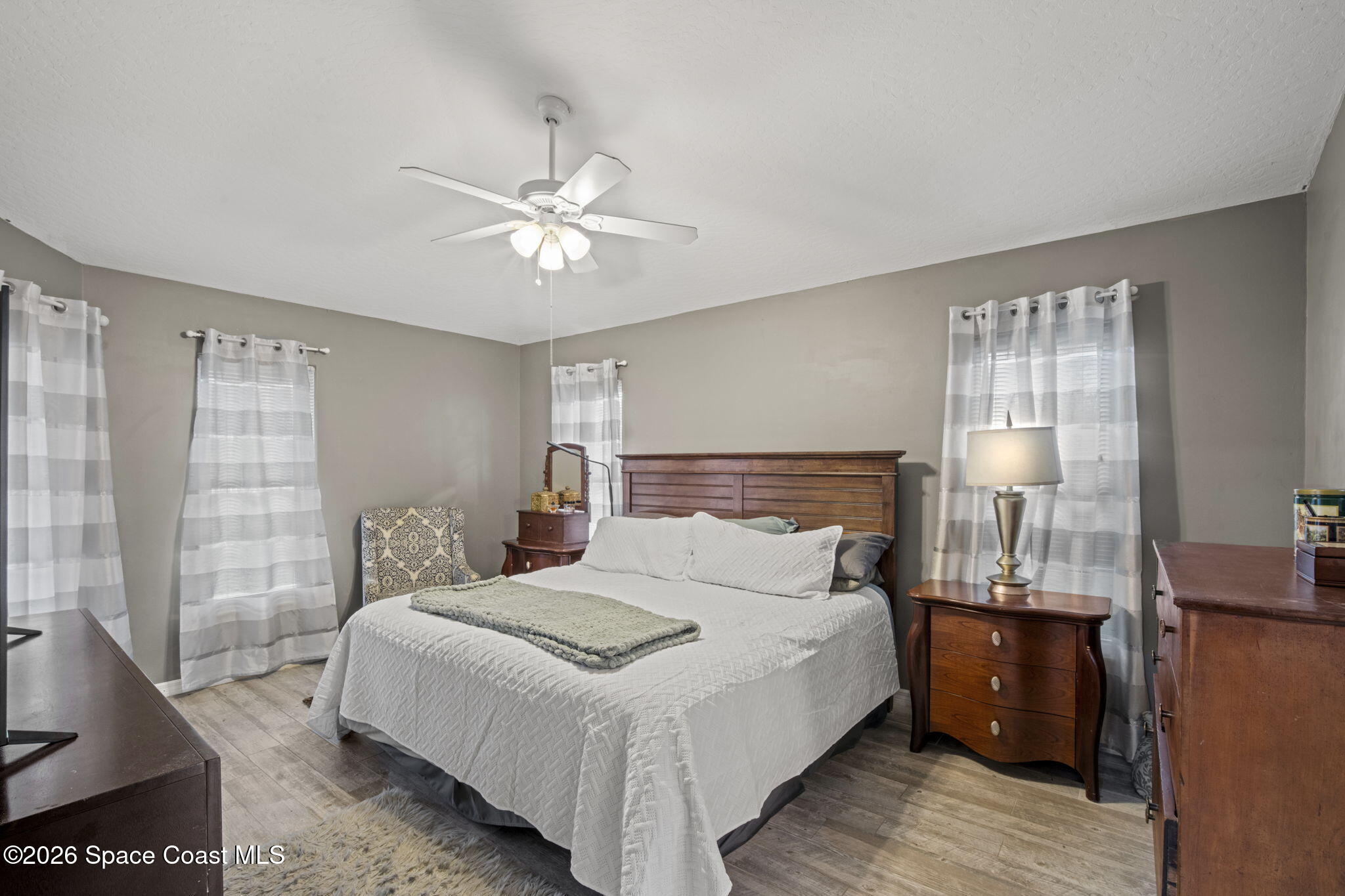472 Arbor Street Sebastian, FL 32958 - Photo 13 of 33 a bedroom with a bed and a chandelier
