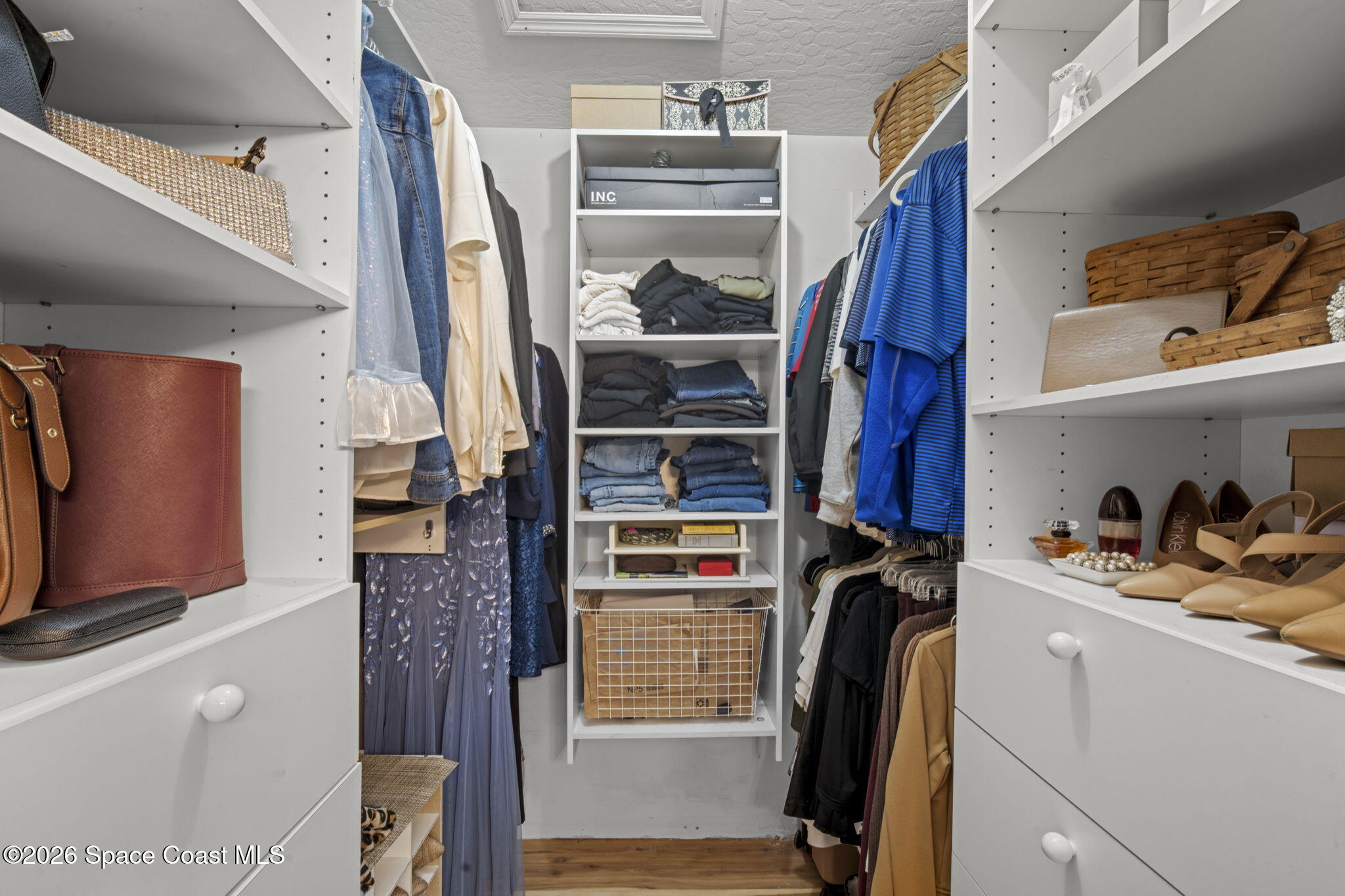 472 Arbor Street Sebastian, FL 32958 - Photo 16 of 33 a view of walk in closet with clothes and shoes