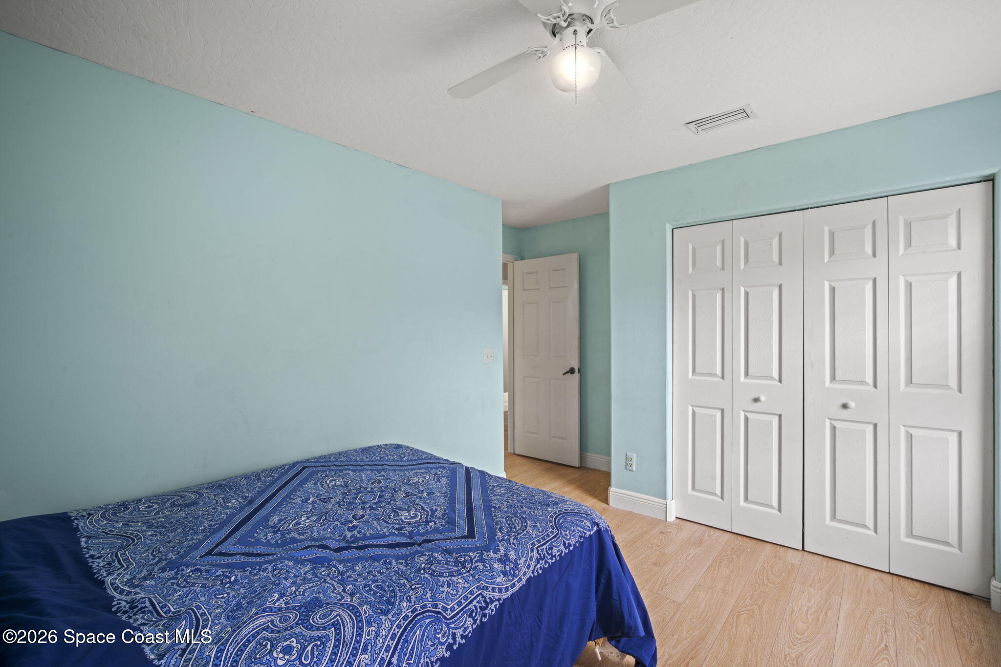472 Arbor Street Sebastian, FL 32958 - Photo 19 of 33 a bedroom with a bed and a chandelier fan