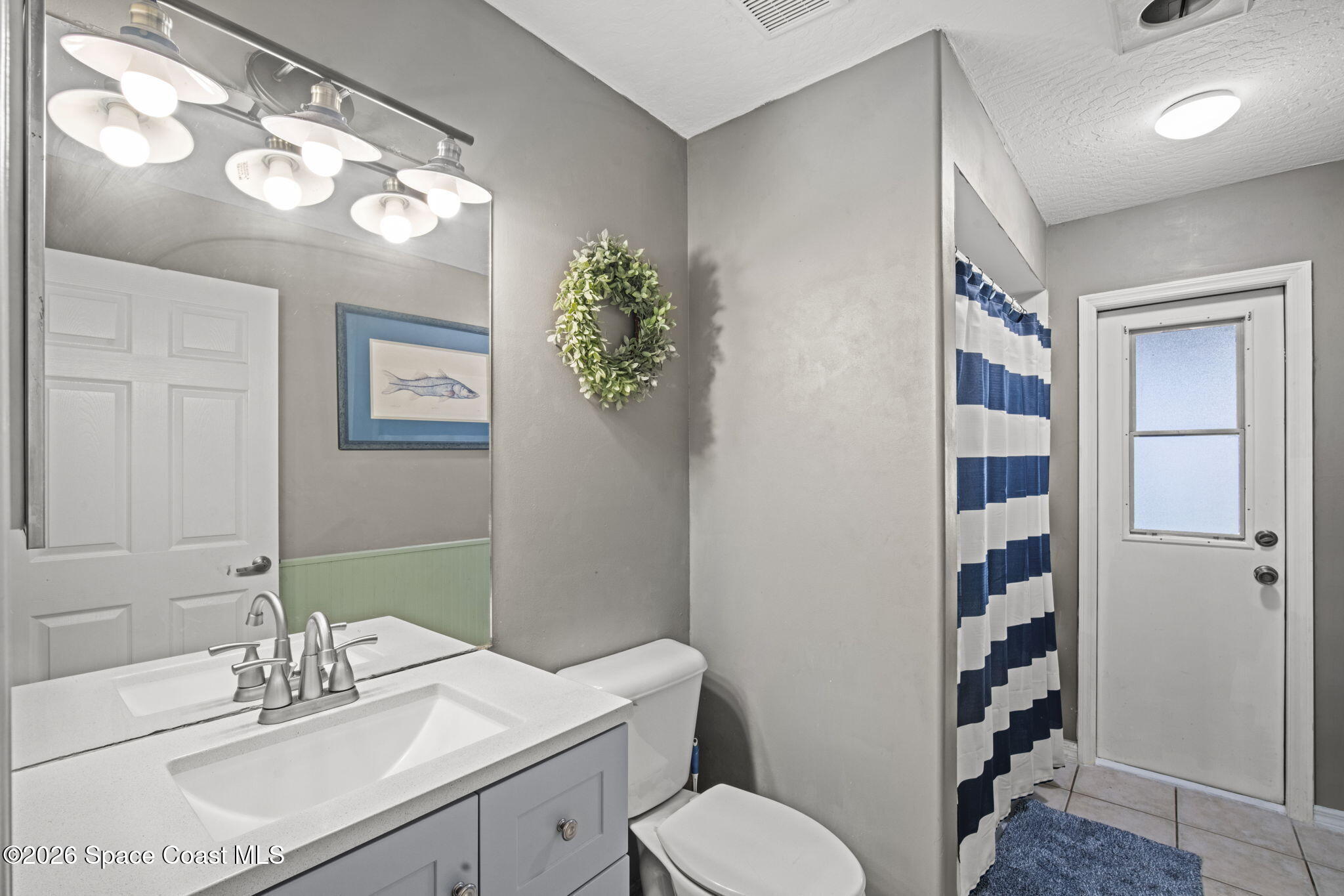 472 Arbor Street Sebastian, FL 32958 - Photo 23 of 33 a bathroom with a sink vanity granite and toilet