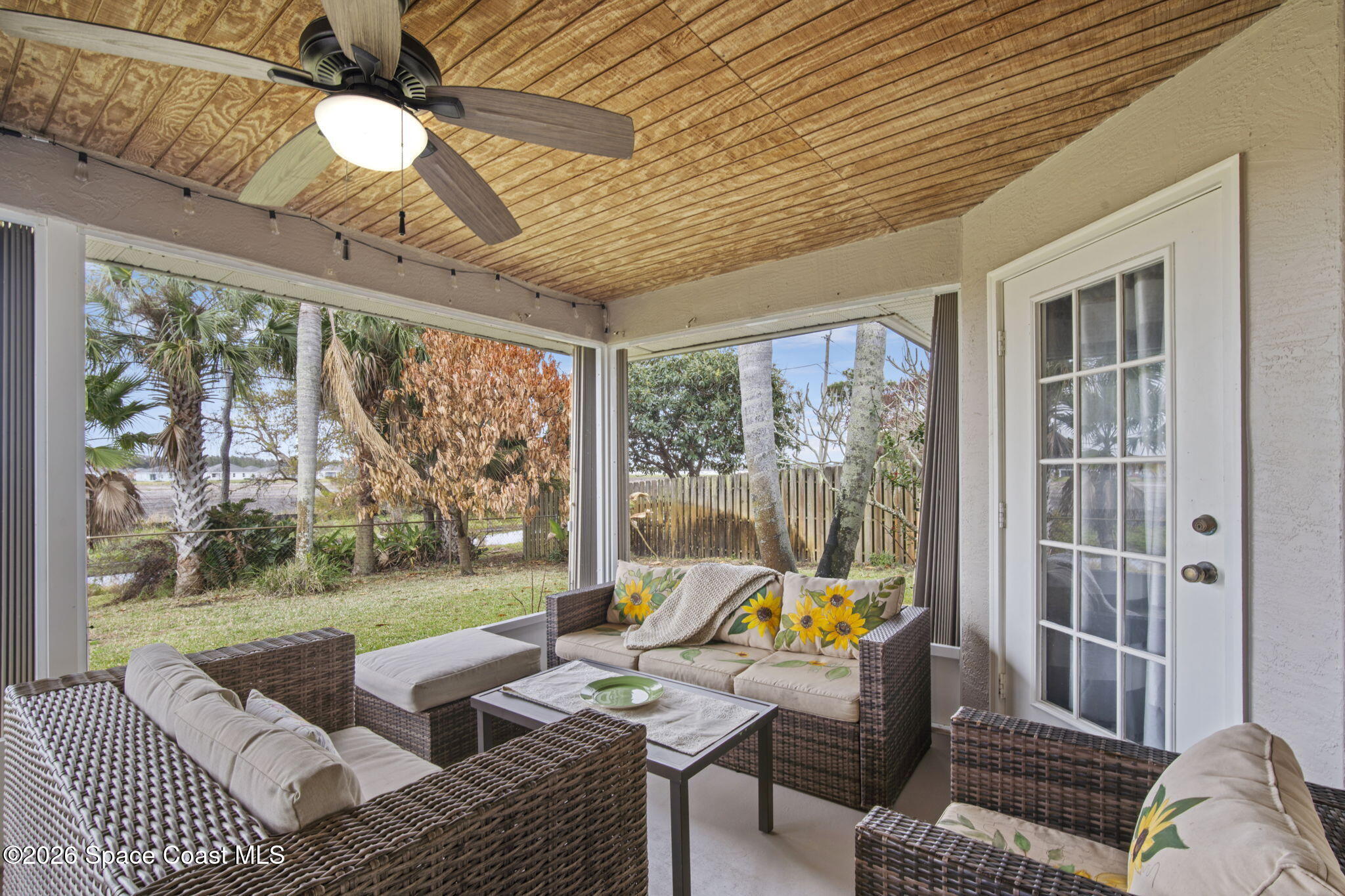 472 Arbor Street Sebastian, FL 32958 - Photo 25 of 33 a living room with furniture and a floor to ceiling window