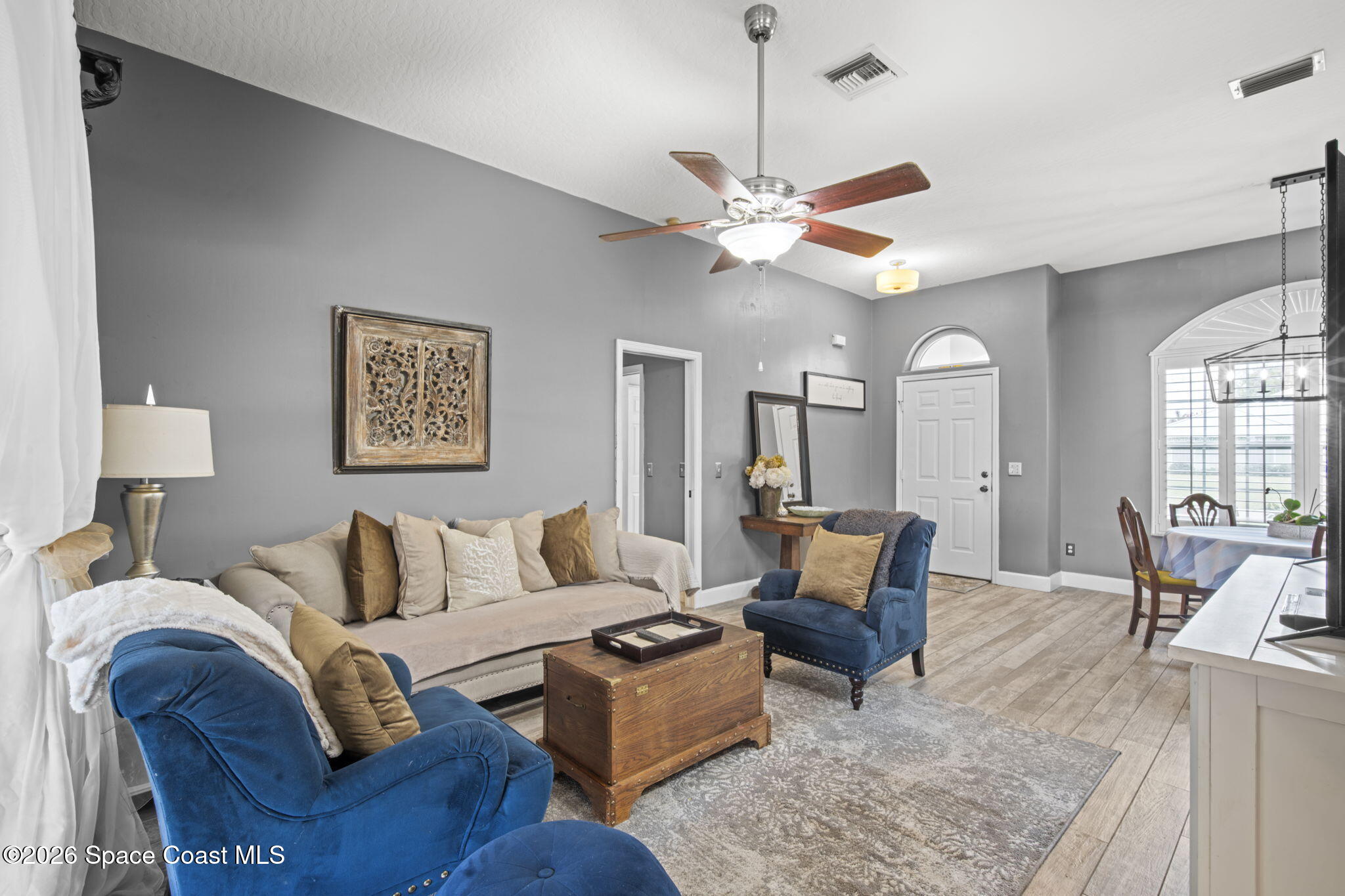 472 Arbor Street Sebastian, FL 32958 - Photo 4 of 33 a living room with furniture a couch and ceiling fan