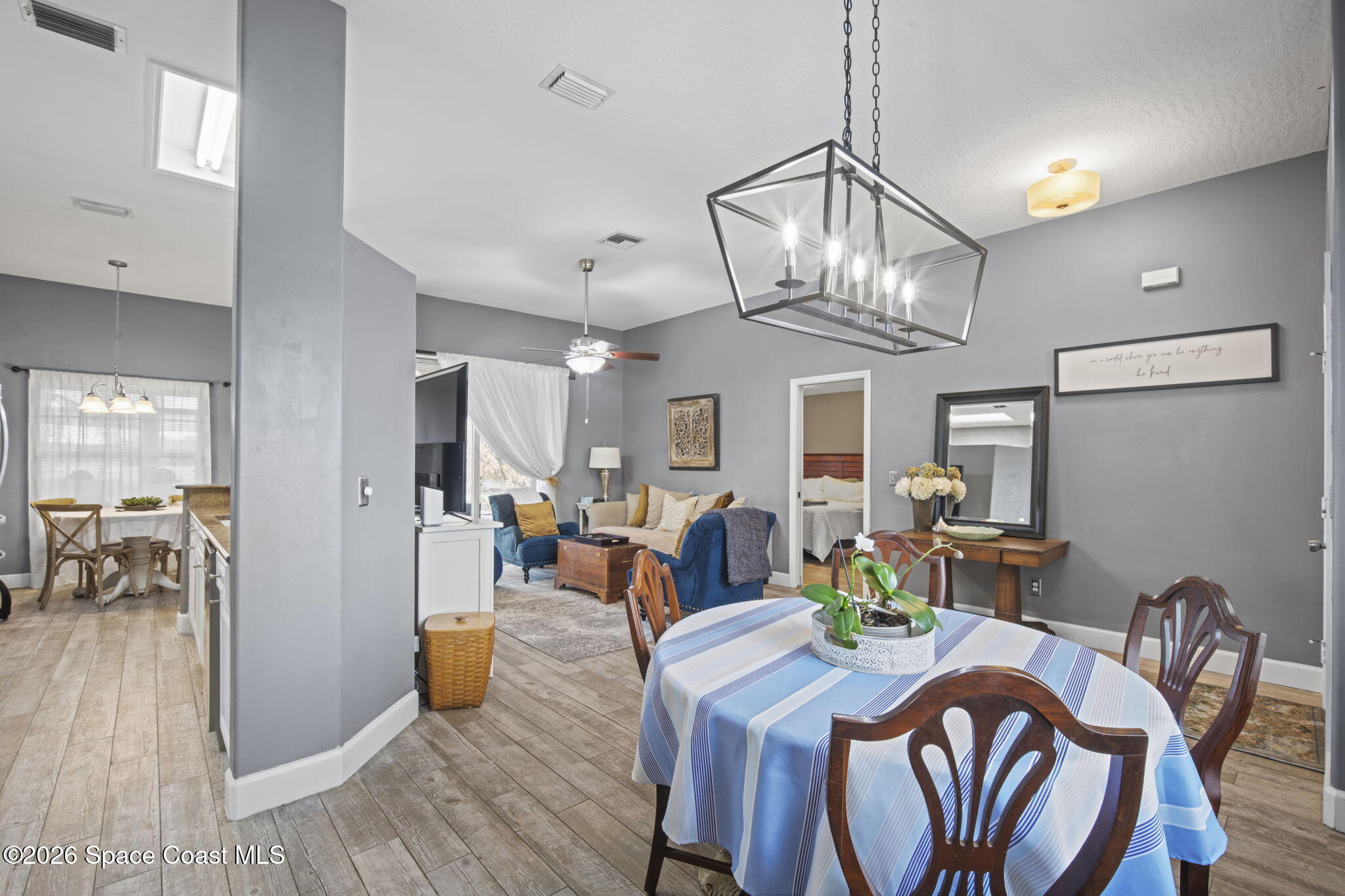 472 Arbor Street Sebastian, FL 32958 - Photo 5 of 33 a view of a dining room with furniture a chandelier and wooden floor