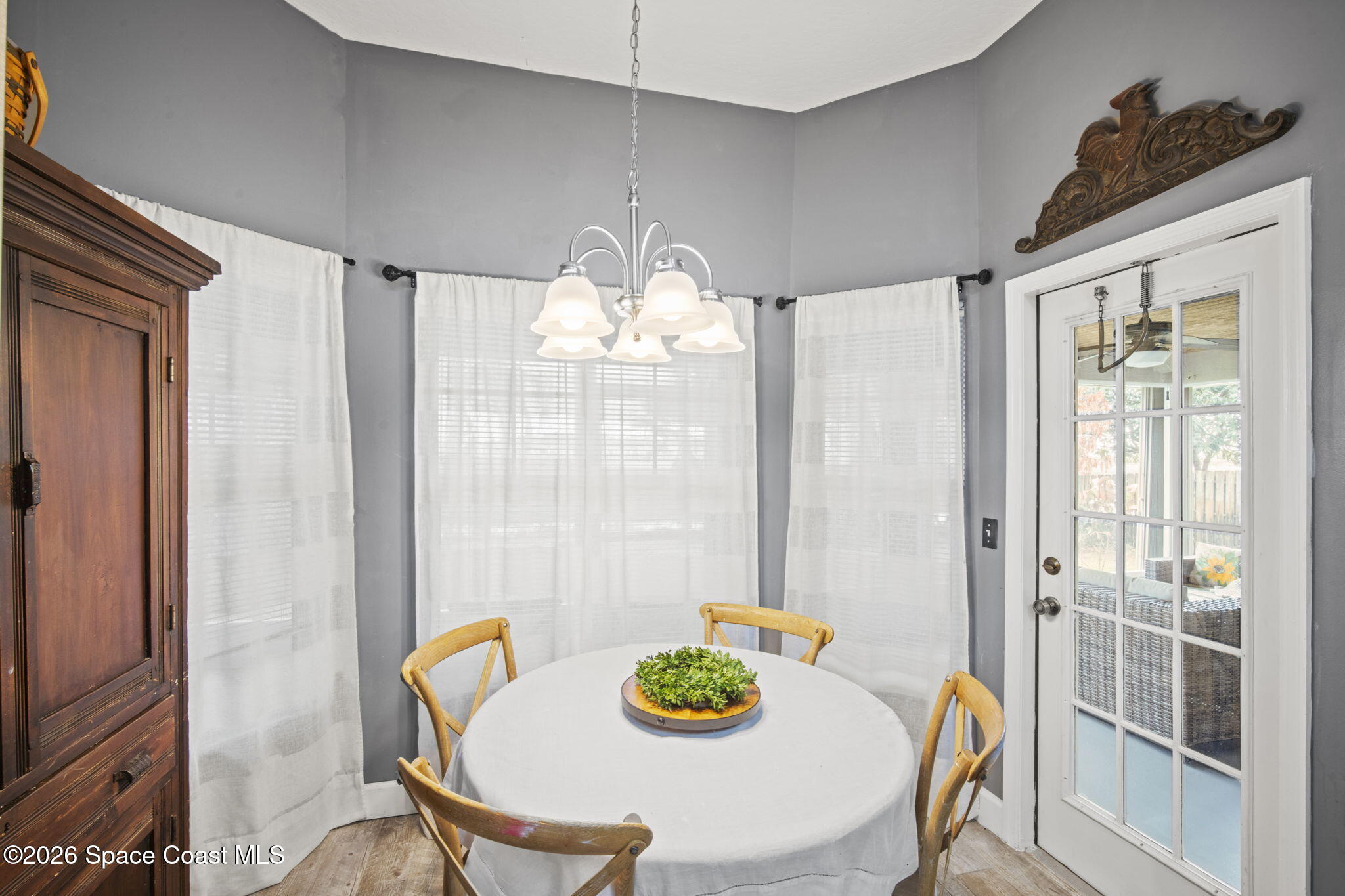 472 Arbor Street Sebastian, FL 32958 - Photo 8 of 33 a view of a dining room with furniture a chandelier and wooden floor