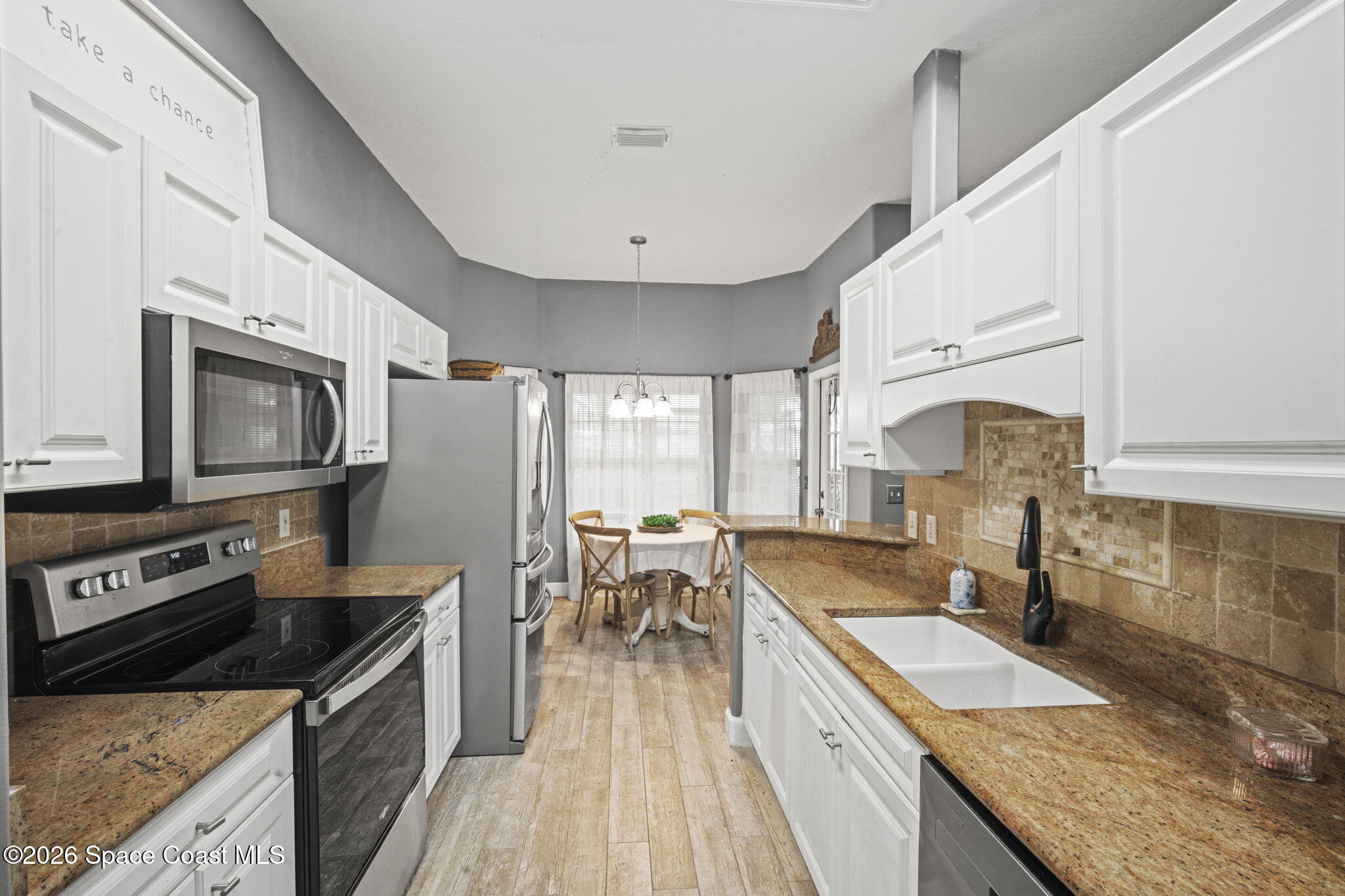 472 Arbor Street Sebastian, FL 32958 - Photo 10 of 33 a kitchen with granite countertop lots of counter top space and stainless steel appliances