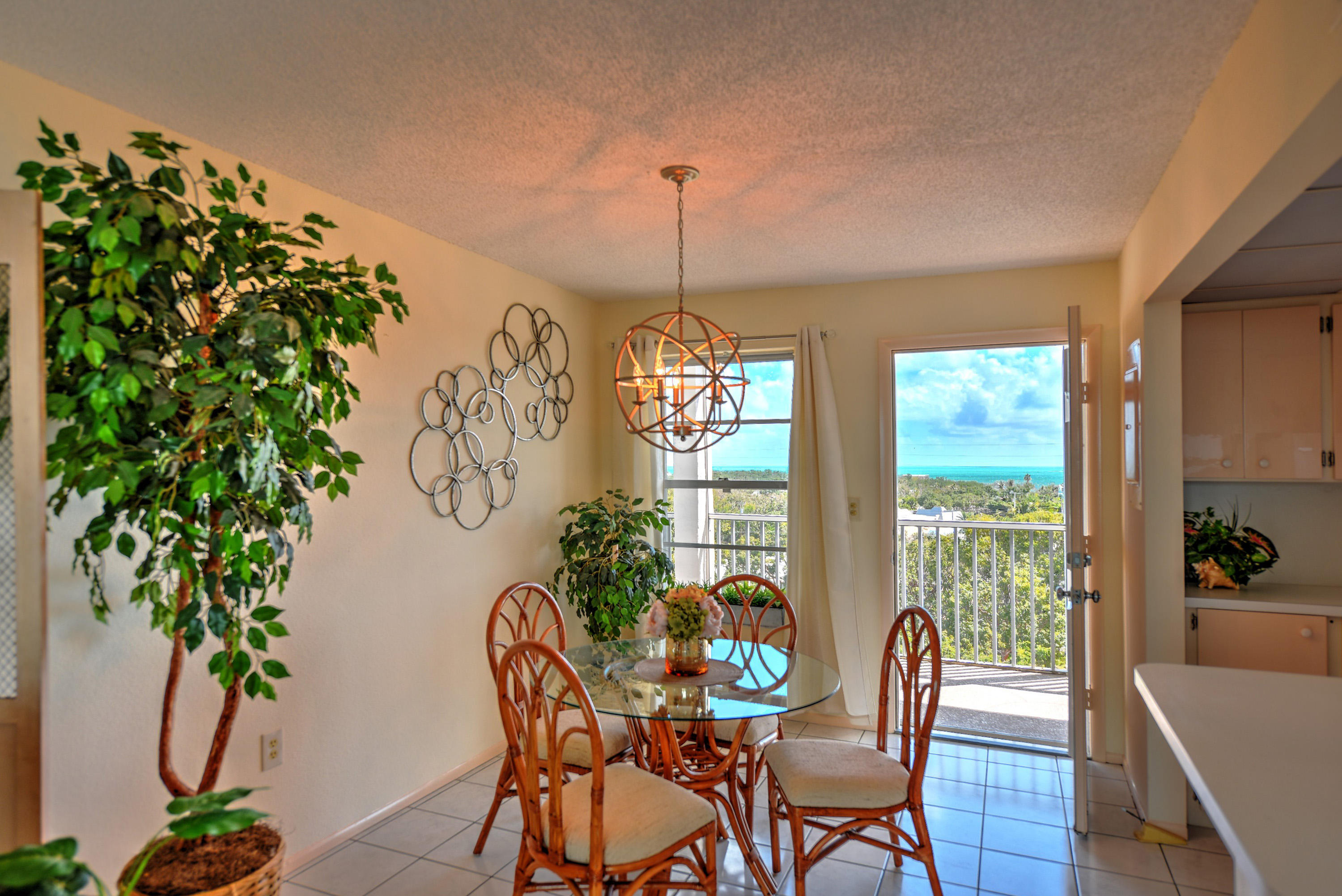200 Harborview Drive, Unit PH 4 Tavernier, FL 33070 - Photo 11 of 33 a dining room with furniture window and wooden floor