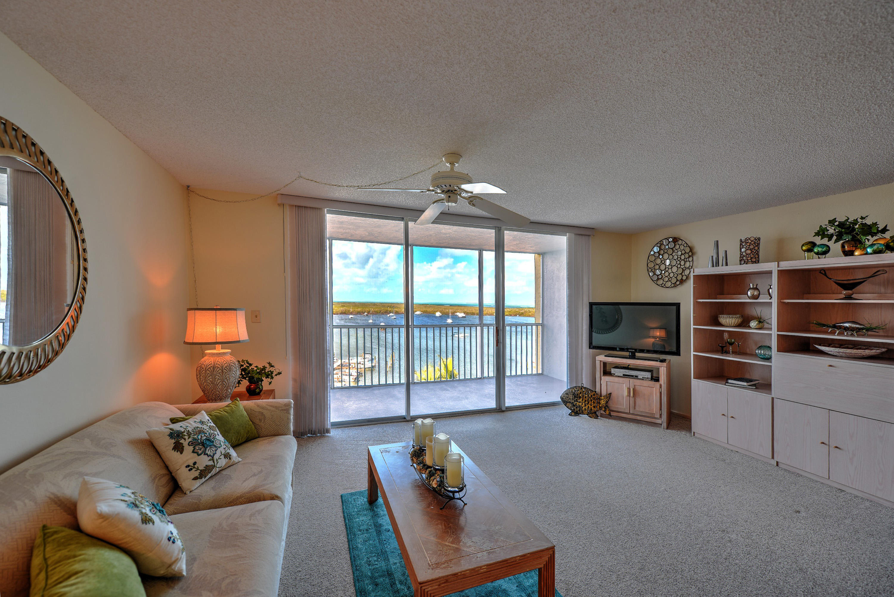 200 Harborview Drive, Unit PH 4 Tavernier, FL 33070 - Photo 13 of 33 a living room with furniture and a flat screen tv