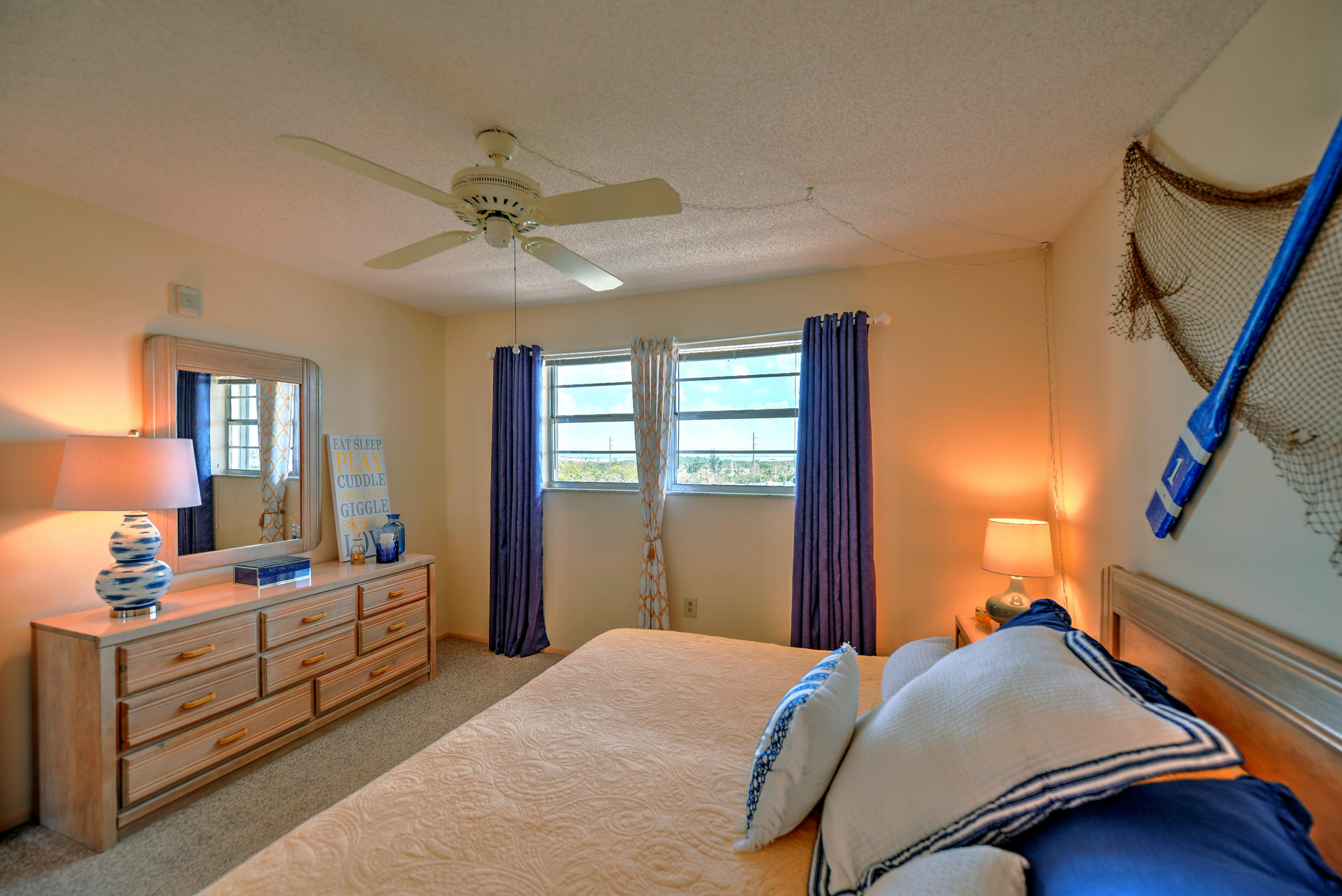 200 Harborview Drive, Unit PH 4 Tavernier, FL 33070 - Photo 14 of 33 a bedroom with a bed and a dresser
