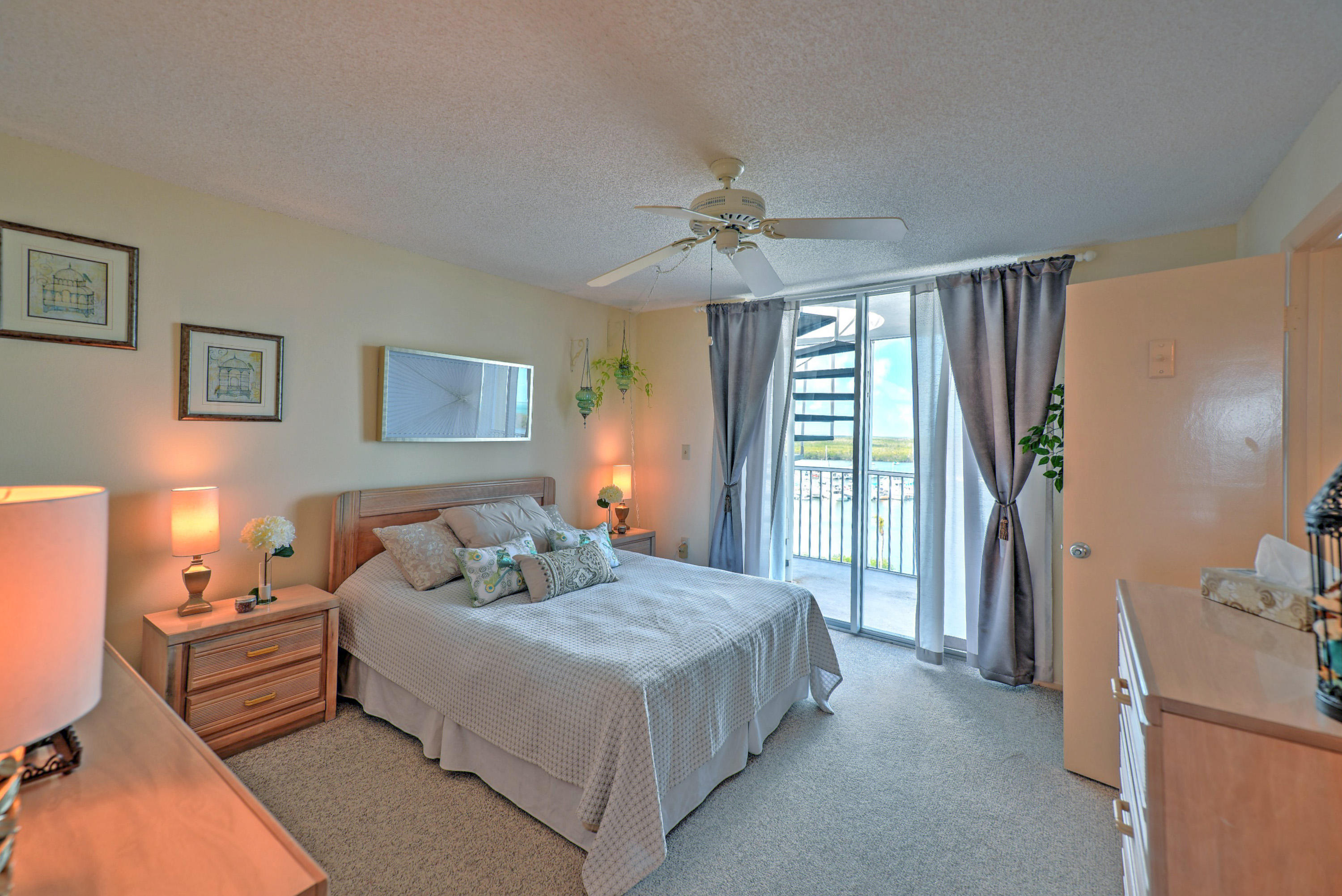 200 Harborview Drive, Unit PH 4 Tavernier, FL 33070 - Photo 17 of 33 a bedroom with a bed couch and a window