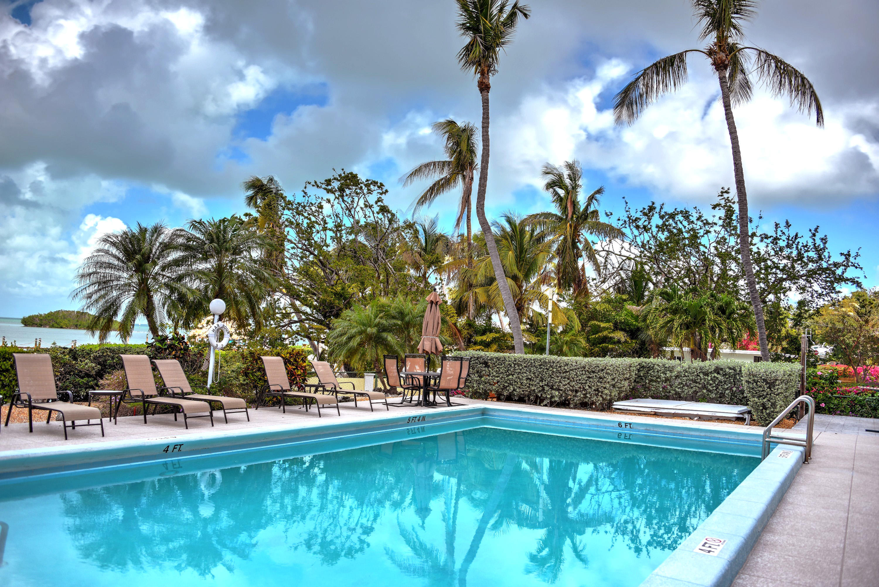 200 Harborview Drive, Unit PH 4 Tavernier, FL 33070 - Photo 27 of 33 a view of swimming pool with a table and chairs