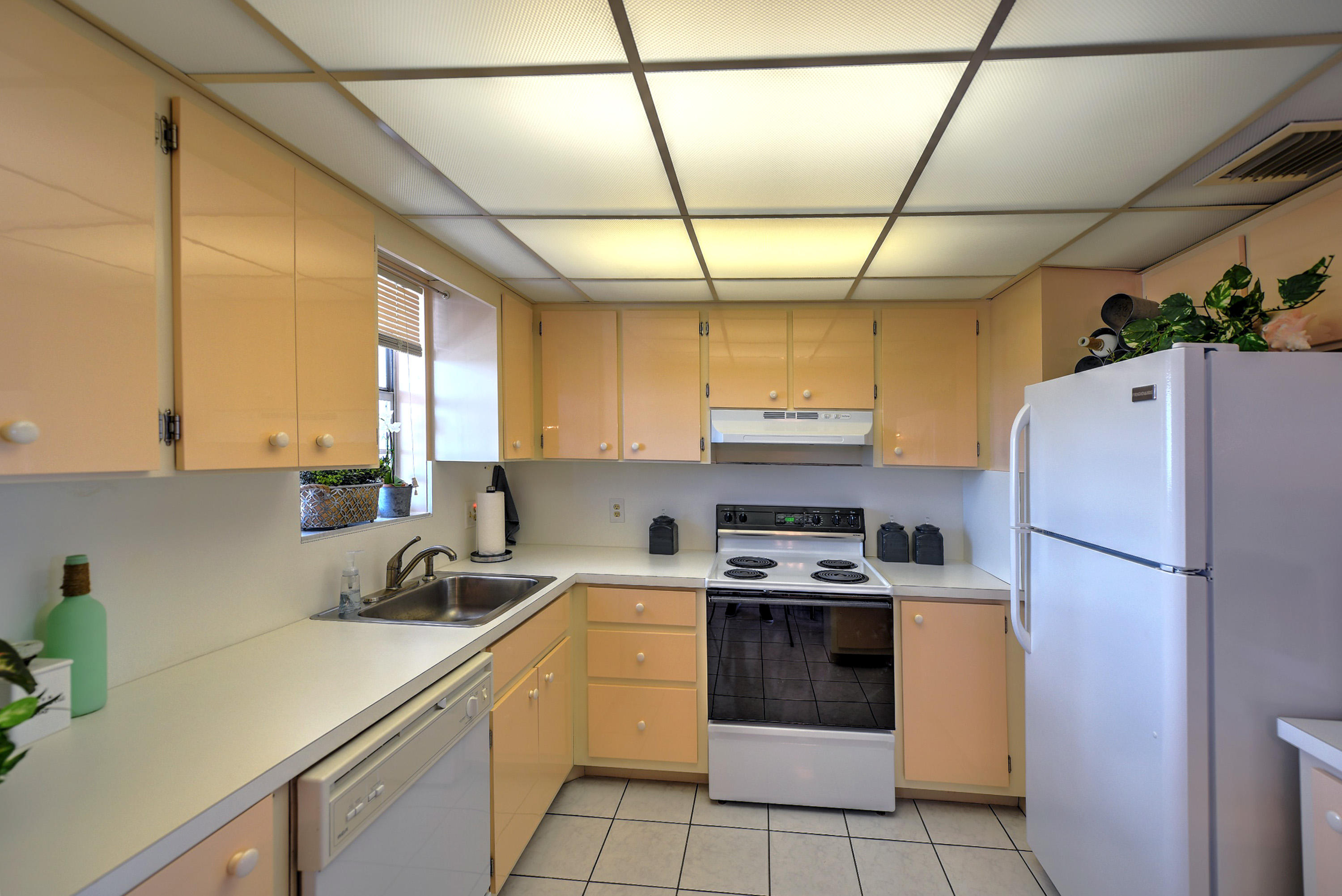 200 Harborview Drive, Unit PH 4 Tavernier, FL 33070 - Photo 9 of 33 a kitchen with a sink a refrigerator and a stove top oven