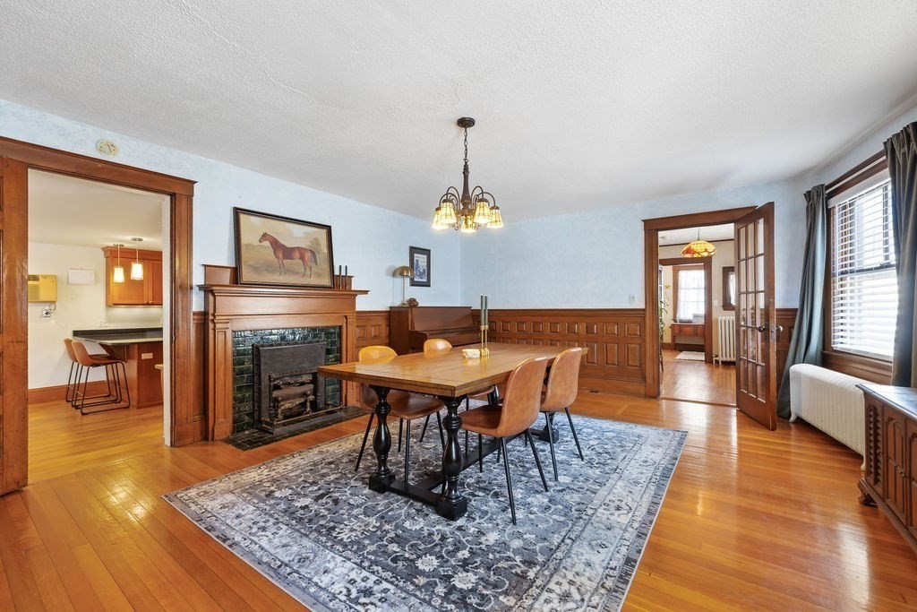 200 Washington Street Boston, MA 02135 - Photo 1 of 27 a living room with dining table and a wooden floor