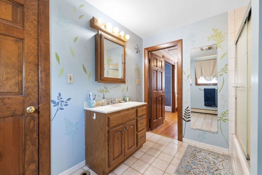 200 Washington Street Boston, MA 02135 - Photo 13 of 27 a bathroom with a sink a toilet and mirror