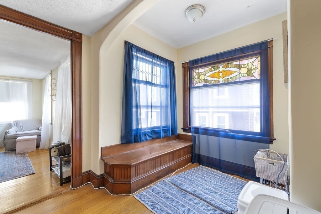 200 Washington Street Boston, MA 02135 - Photo 14 of 27 a bedroom with a bed and wooden floor