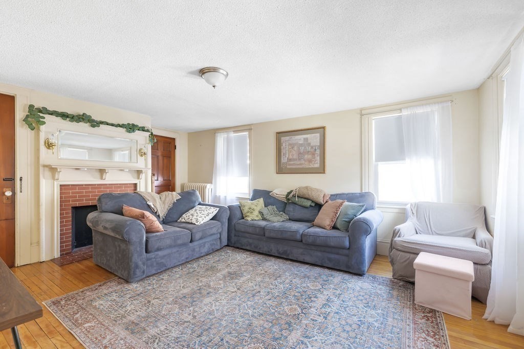 200 Washington Street Boston, MA 02135 - Photo 15 of 27 a living room with furniture and a large window