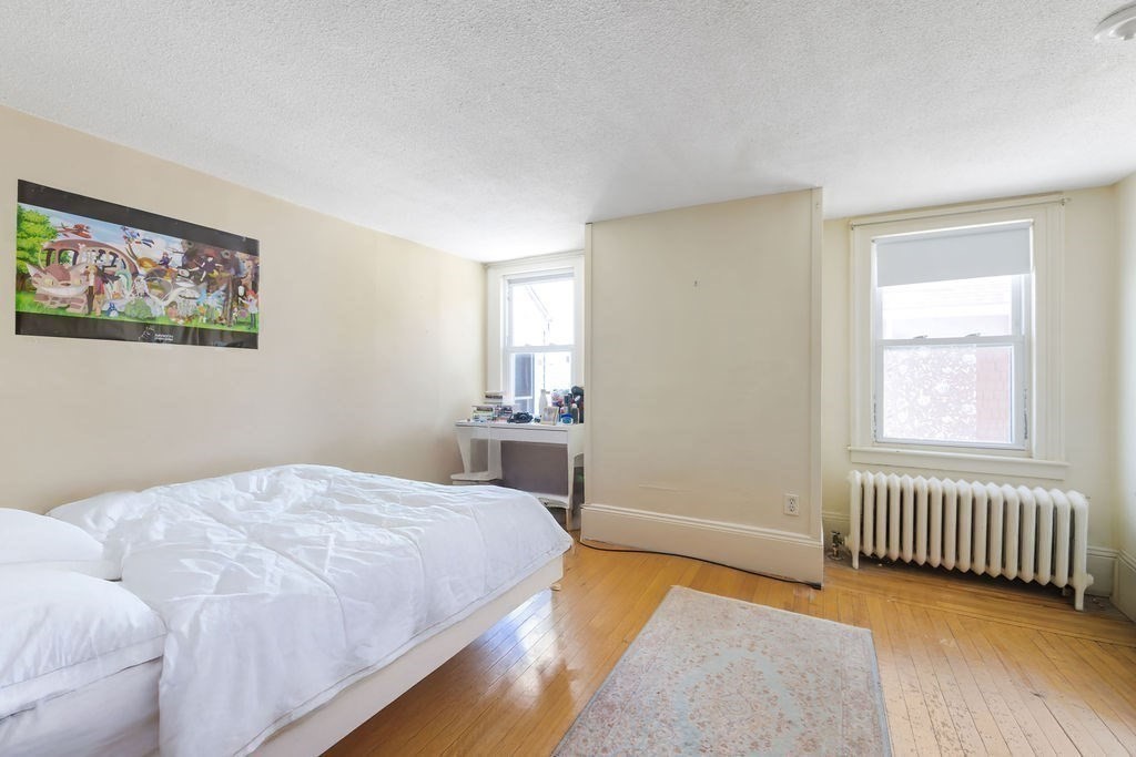 200 Washington Street Boston, MA 02135 - Photo 20 of 27 a bedroom with a bed and a window