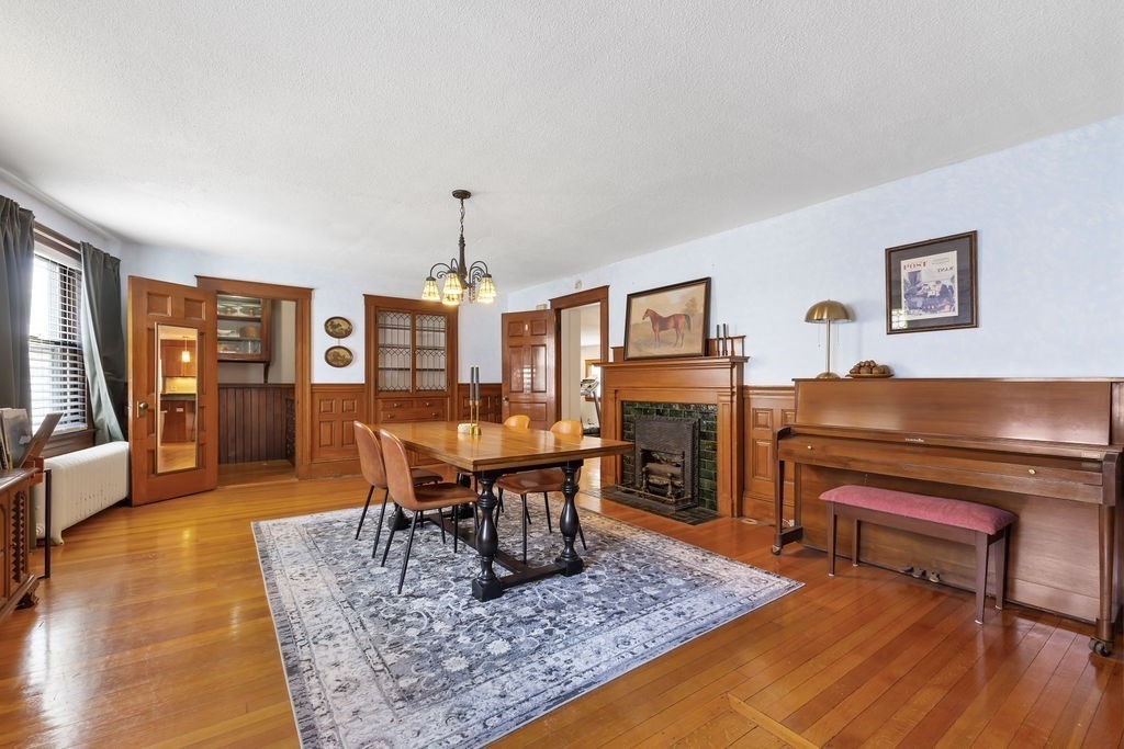 200 Washington Street Boston, MA 02135 - Photo 2 of 27 a living room with furniture a piano and a fireplace