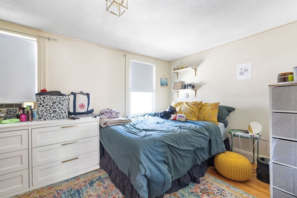 200 Washington Street Boston, MA 02135 - Photo 21 of 27 a bedroom with a bed and cabinets