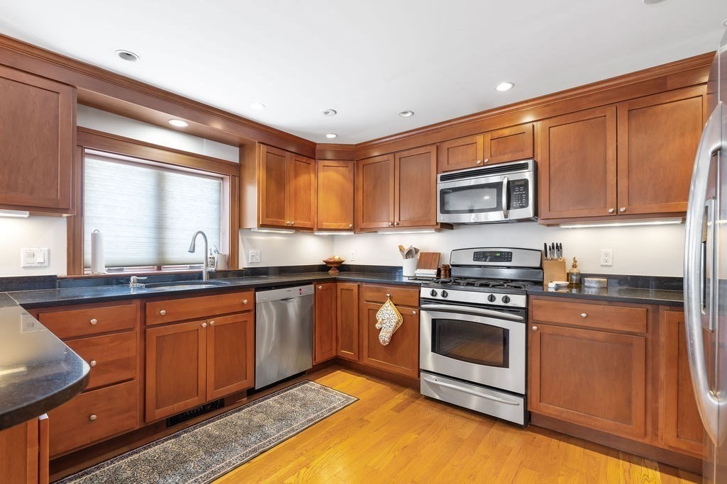 200 Washington Street Boston, MA 02135 - Photo 6 of 27 a kitchen with stainless steel appliances granite countertop a stove sink and microwave