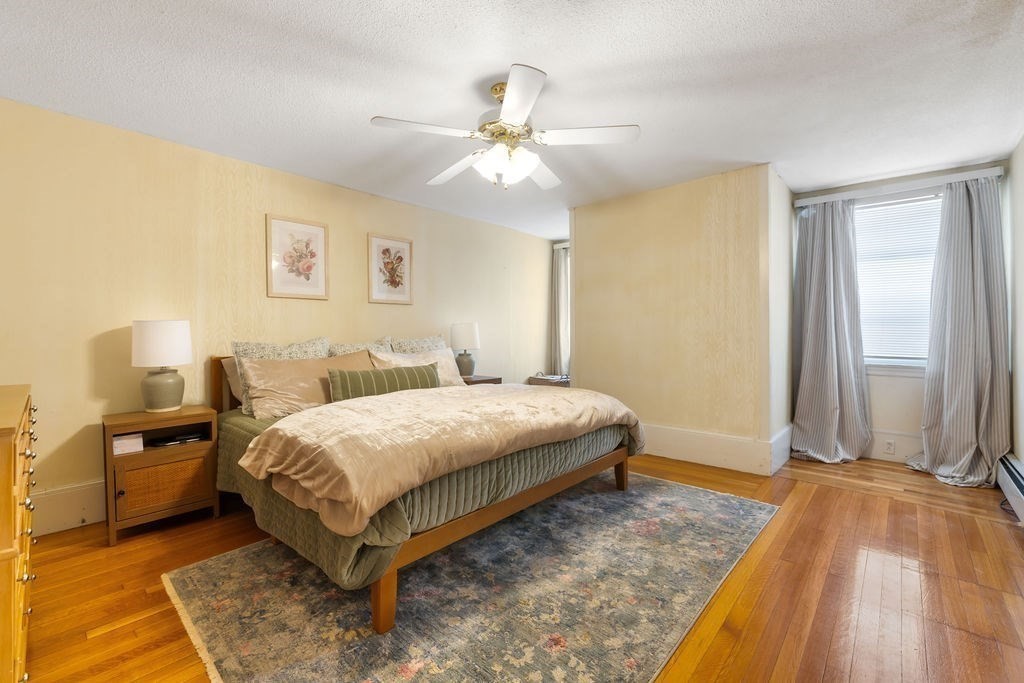 200 Washington Street Boston, MA 02135 - Photo 9 of 27 a bedroom with a bed and a chandelier