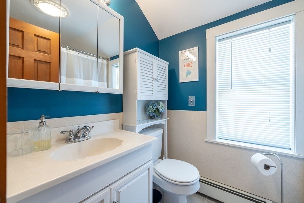 200 Washington Street Boston, MA 02135 - Photo 10 of 27 a bathroom with a sink and a mirror