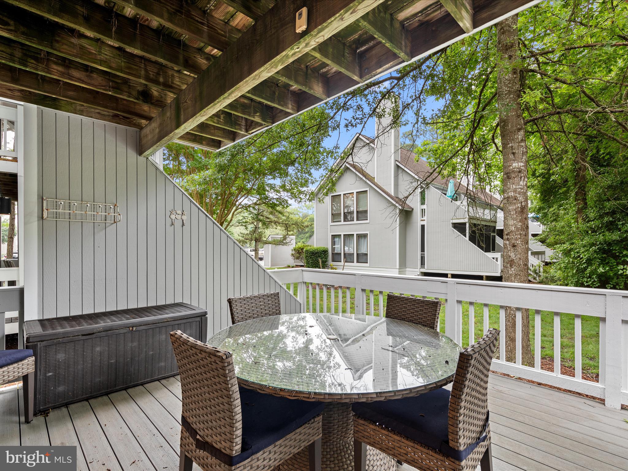 39346 Racquet Lane, Unit 8504 Bethany Beach, DE 19930 - Photo 31 of 40 a view of balcony with wooden floor and outdoor seating