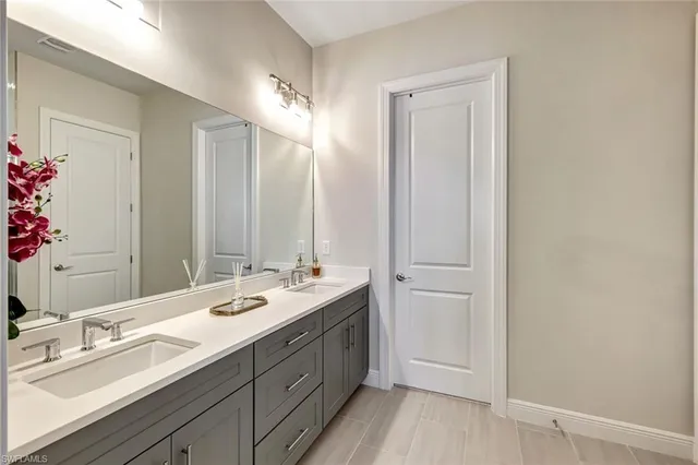 a spacious bathroom with a double vanity sink and a mirror
