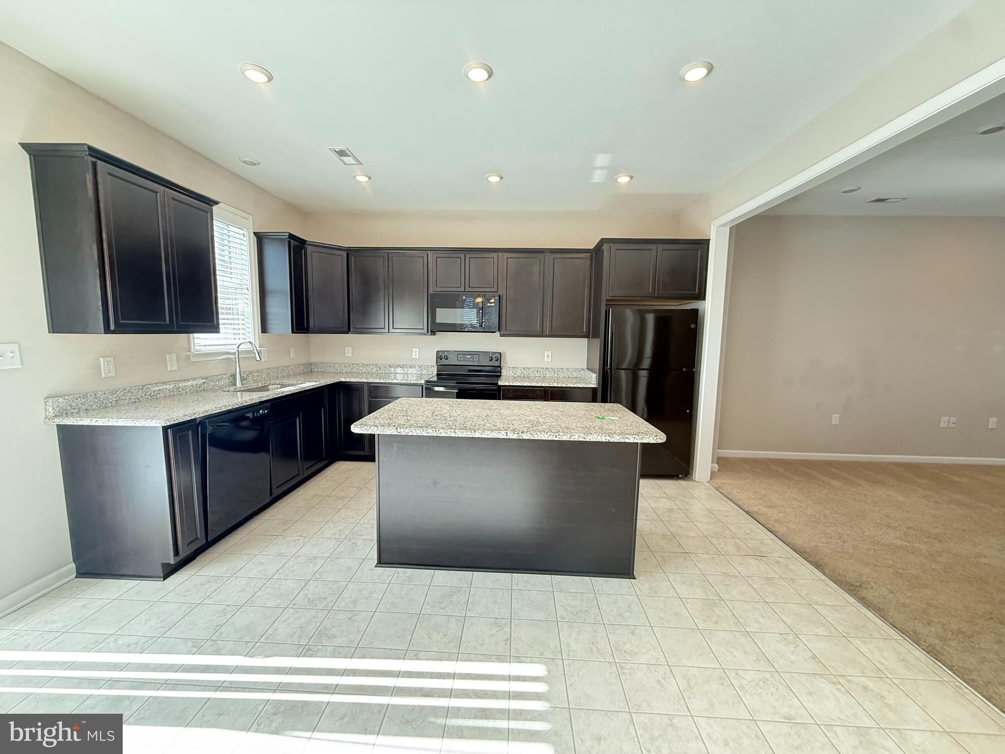 217 Brooks Circle Winchester, VA 22601 - Photo 3 of 9 a large kitchen with stainless steel appliances kitchen island granite countertop a large counter top and a stove