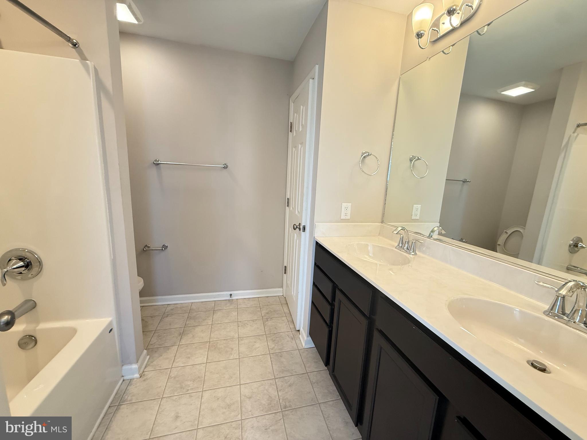 217 Brooks Circle Winchester, VA 22601 - Photo 6 of 9 a bathroom with a tub sink shower and mirror