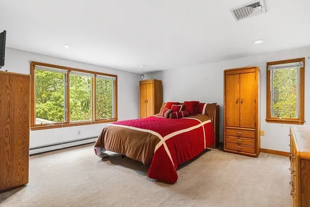 a backyard of a house with lots of plants and large trees