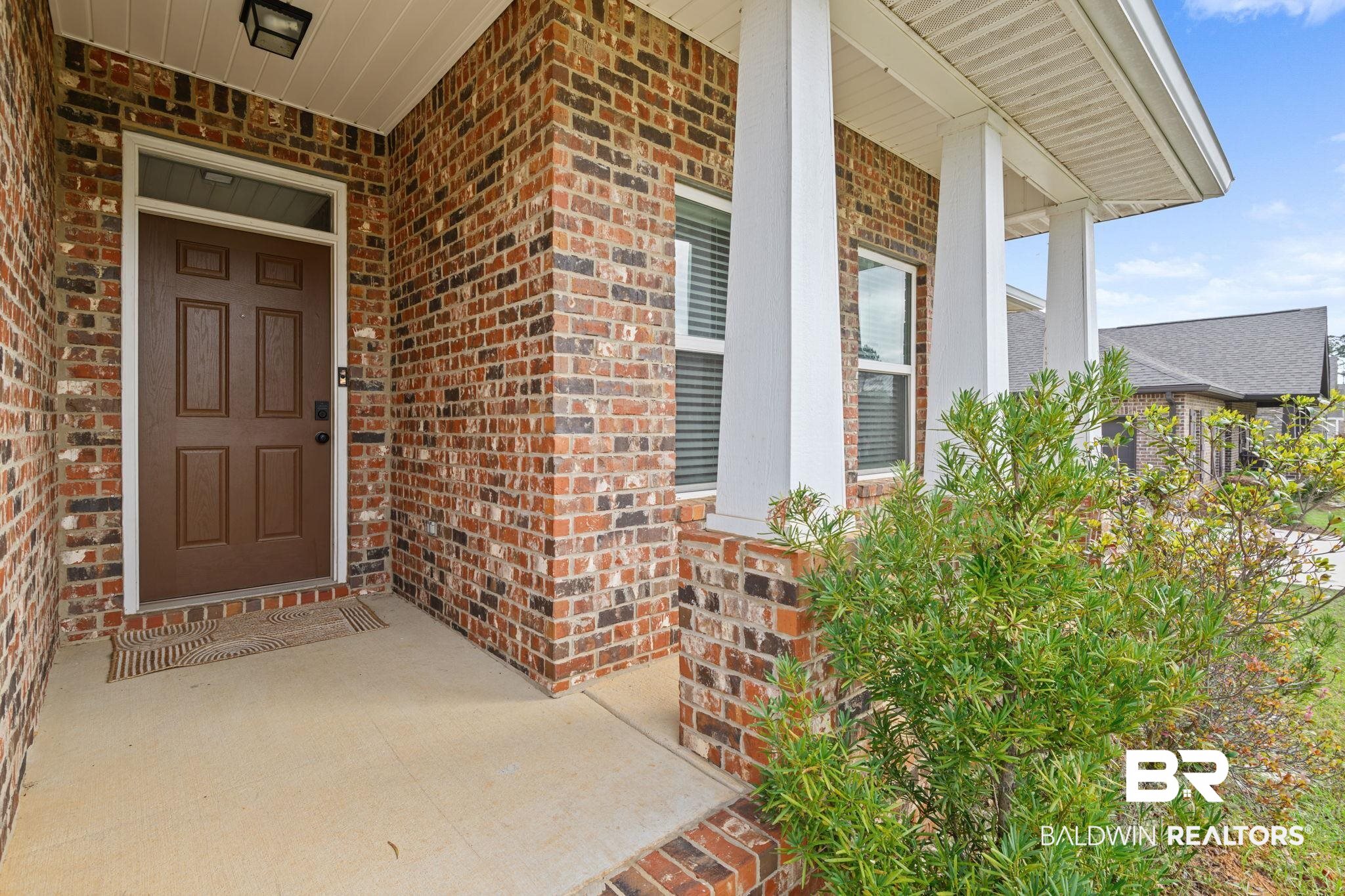 12693 Waxwing Avenue Daphne, AL 36527 - Photo 6 of 43 Property entrance featuring a porch and brick siding