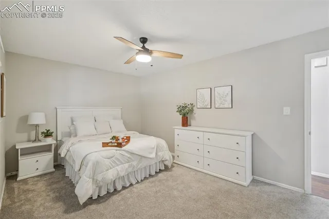 a bedroom with a bed and a potted plant