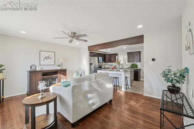 a living room with furniture and kitchen view