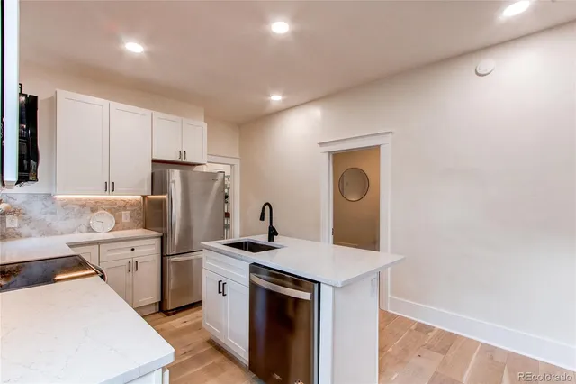 a kitchen with a refrigerator sink and stove