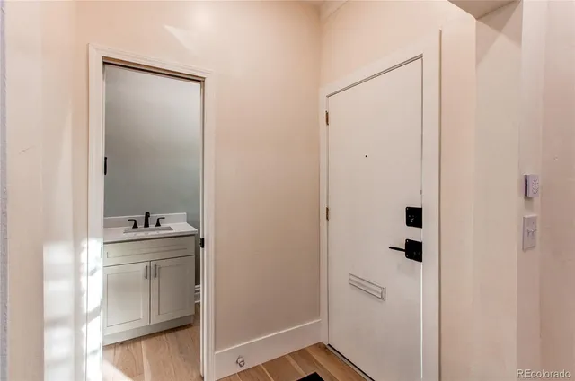 a bathroom with a sink and mirror with toilet